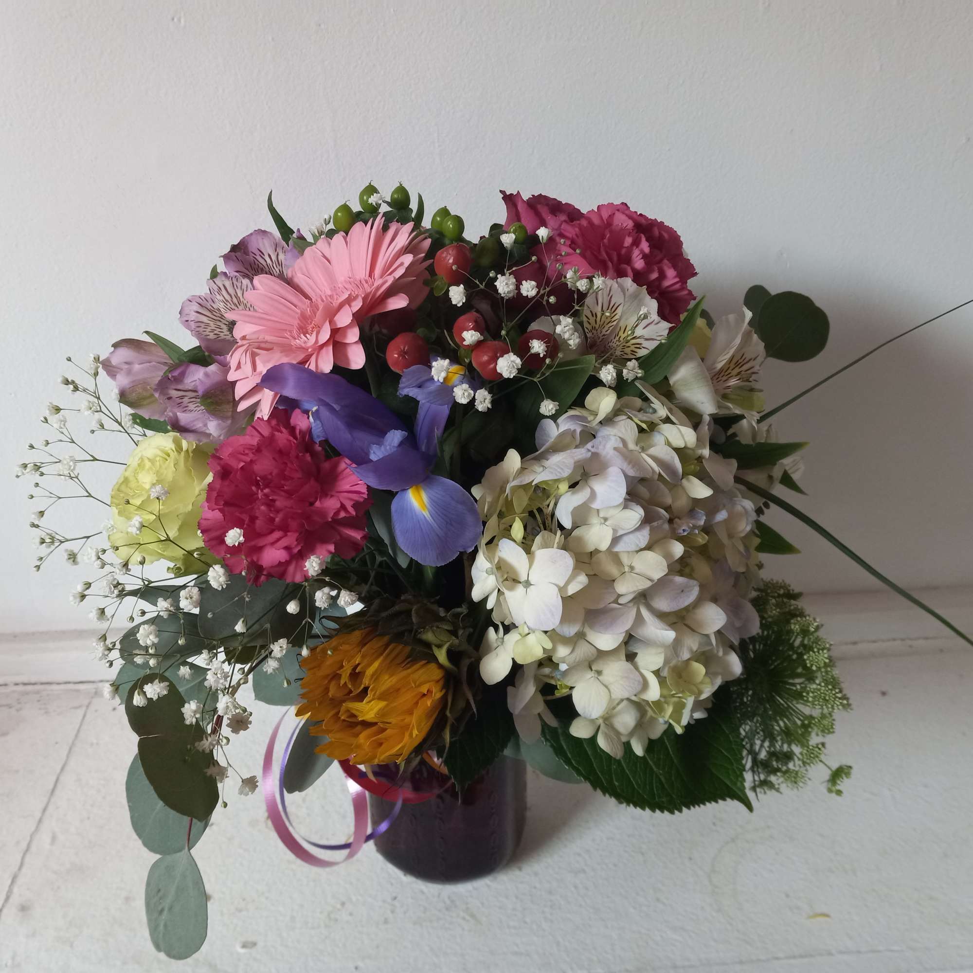 Artistic mix of varied flowers sprinkled with babith breath 