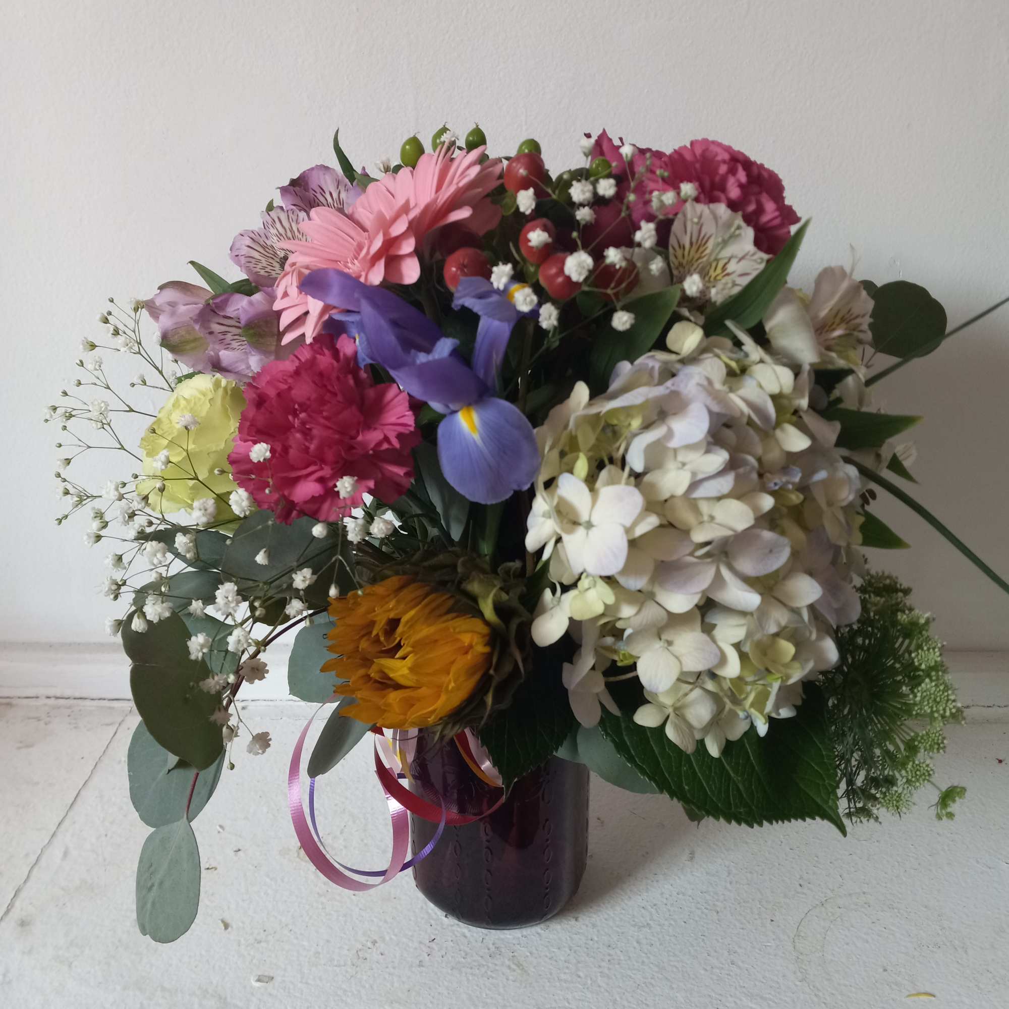 Artistic mix of varied flowers sprinkled with babith breath 