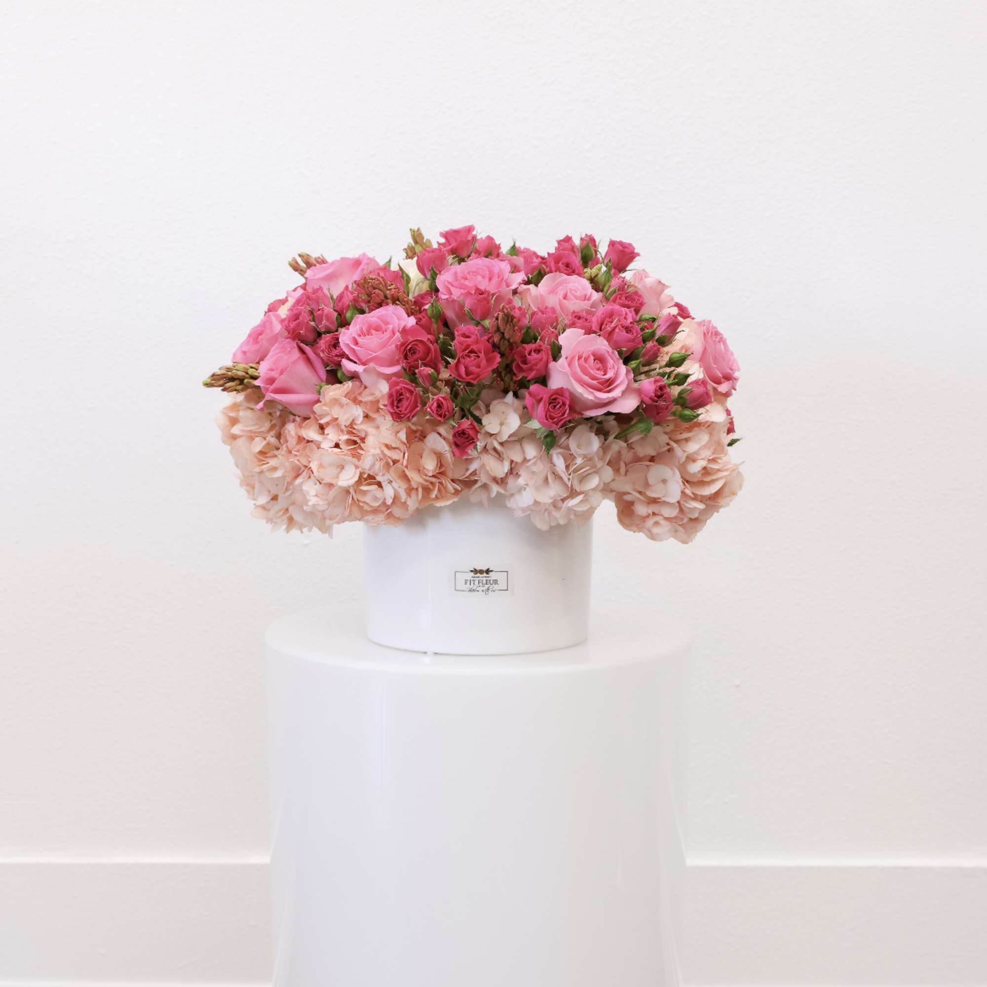 Arrangement includes the folly flowers; hydrangea, spray roses, and roses.