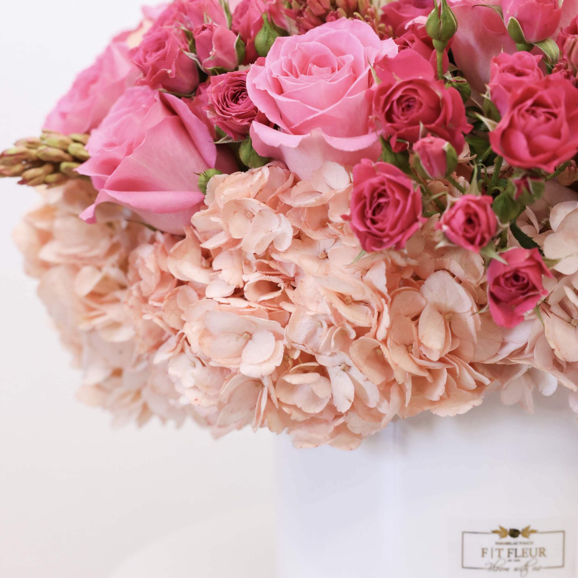 Arrangement includes the folly flowers; hydrangea, spray roses, and roses.