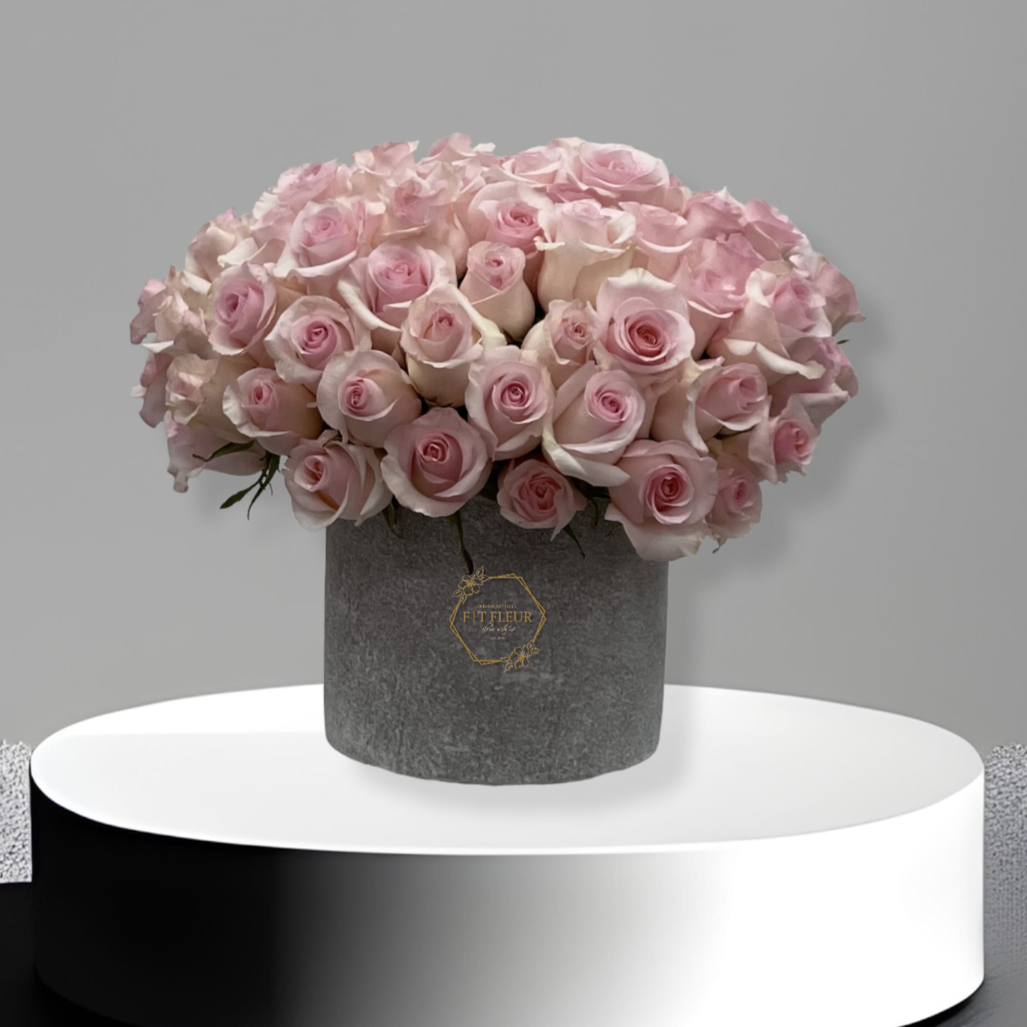 This arrangement comes in a clay vase filed with roses all around.