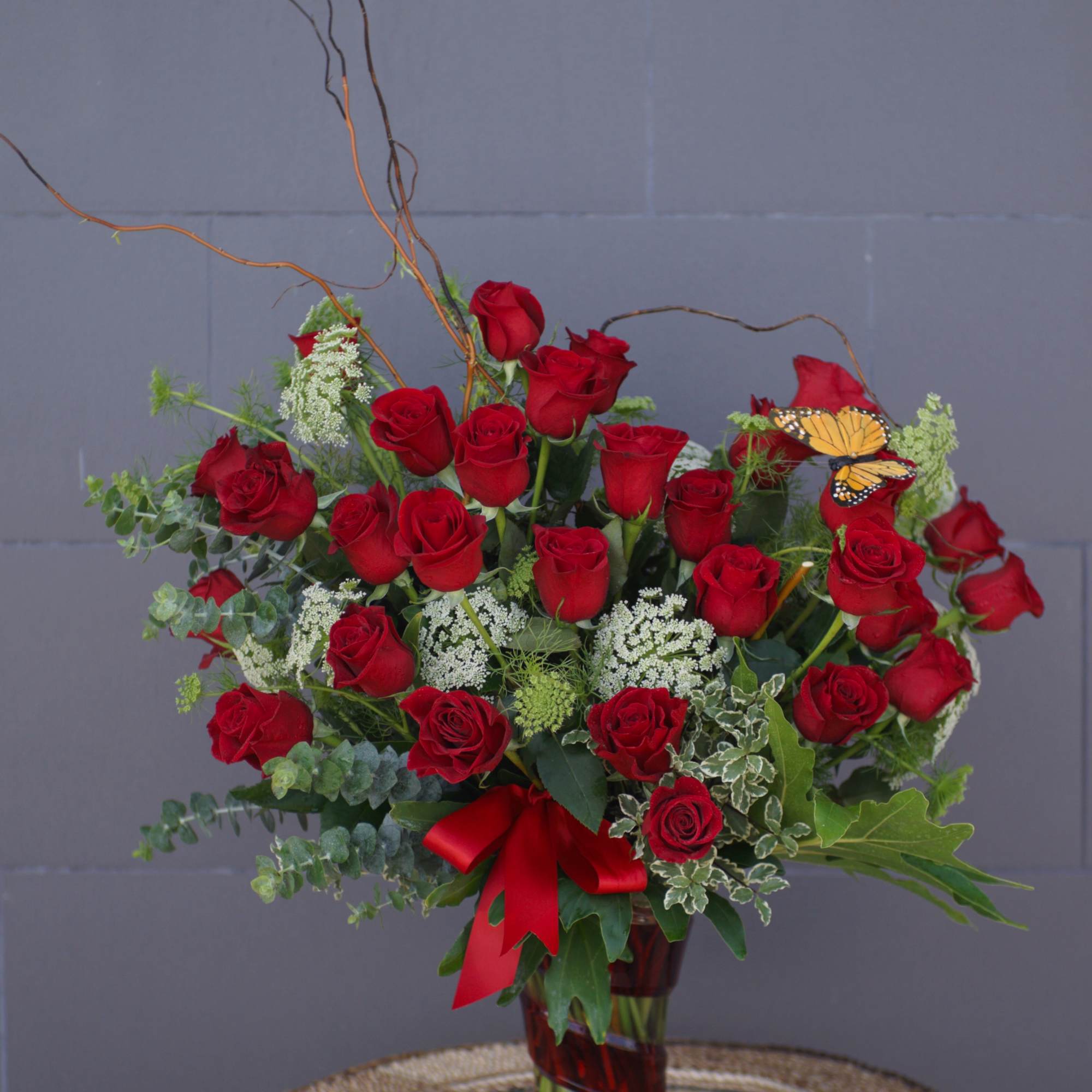 Beautiful design including long-stem Ecuadorian roses and accents in a nice tall Beautiful design including long-stem Ecuadorian roses and accents in a nice tall
