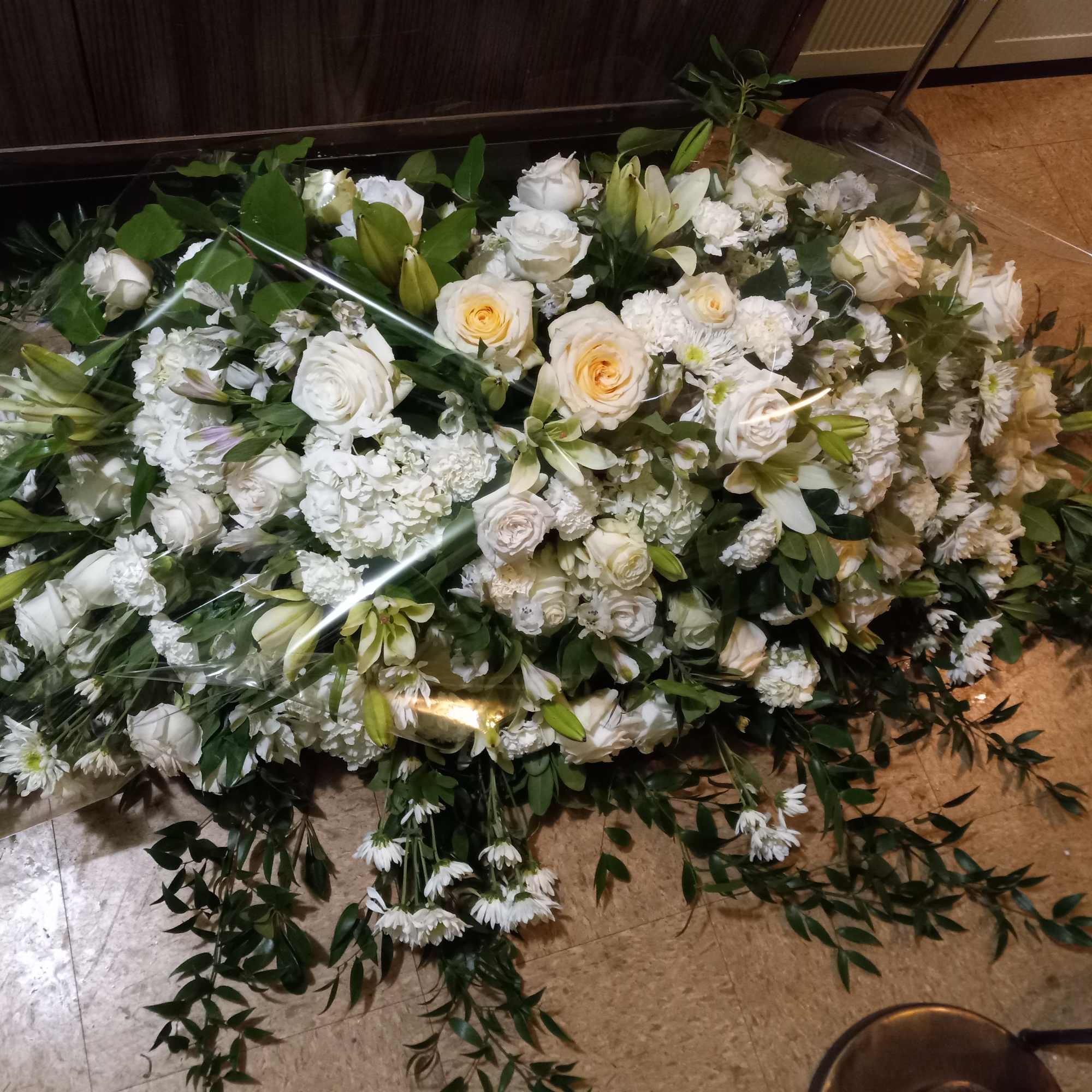 Whole casket spray of white roses, lilies, daisies, alstroemeria and carnations