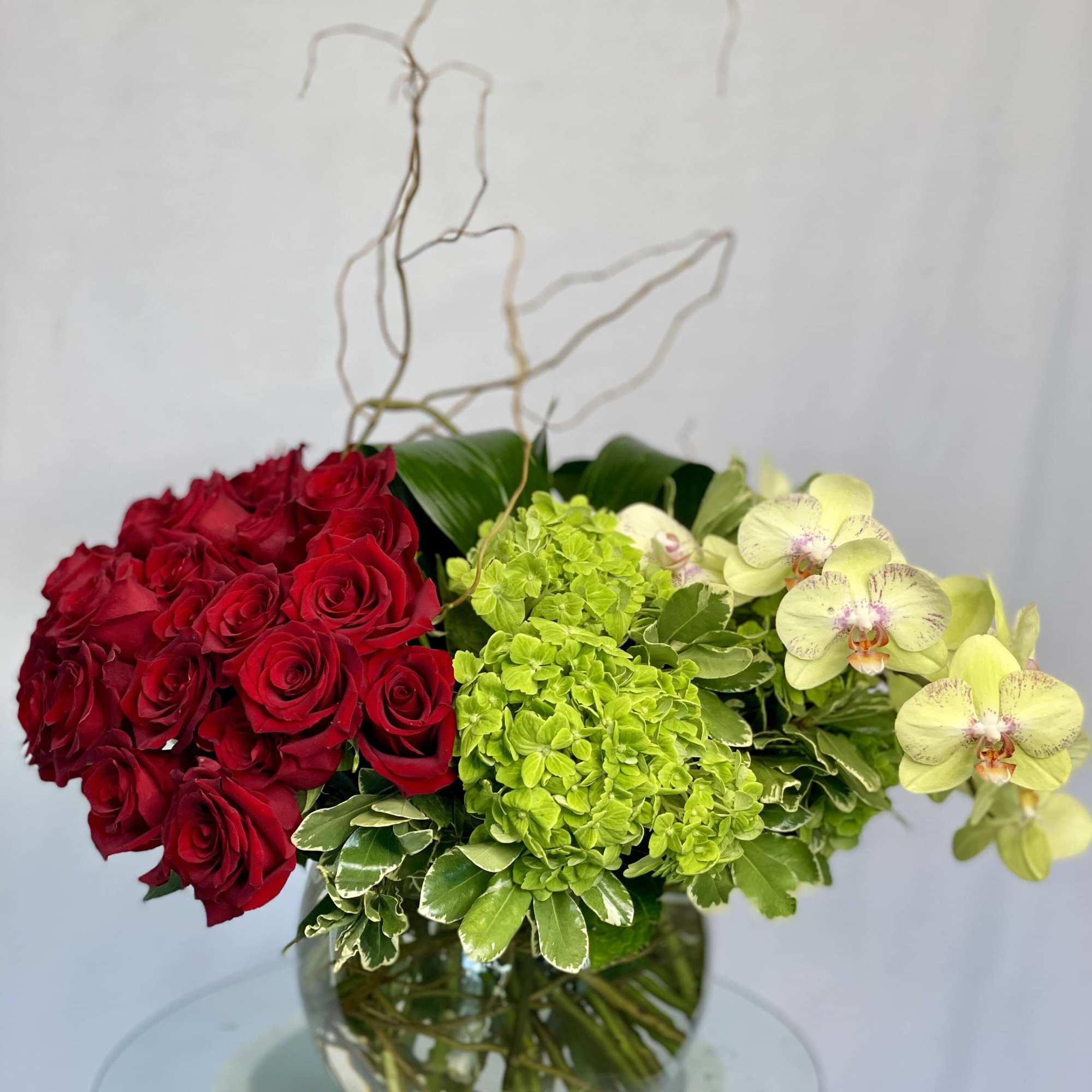 An amazing design containing Red Rose, Dusty Miller Curly Willow, Green  An amazing design containing Red Rose, Dusty Miller Curly Willow, Green