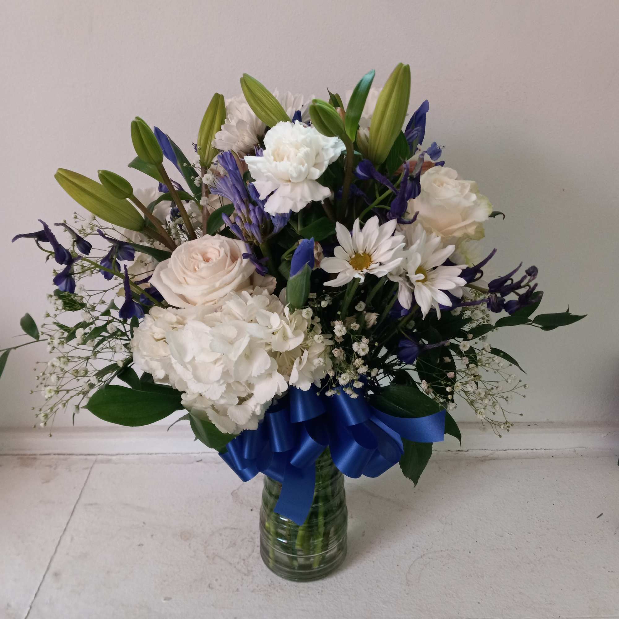 Beautiful mix of white roses, daisies, carnations, hydrangea &amp; navy/blue irises, statice