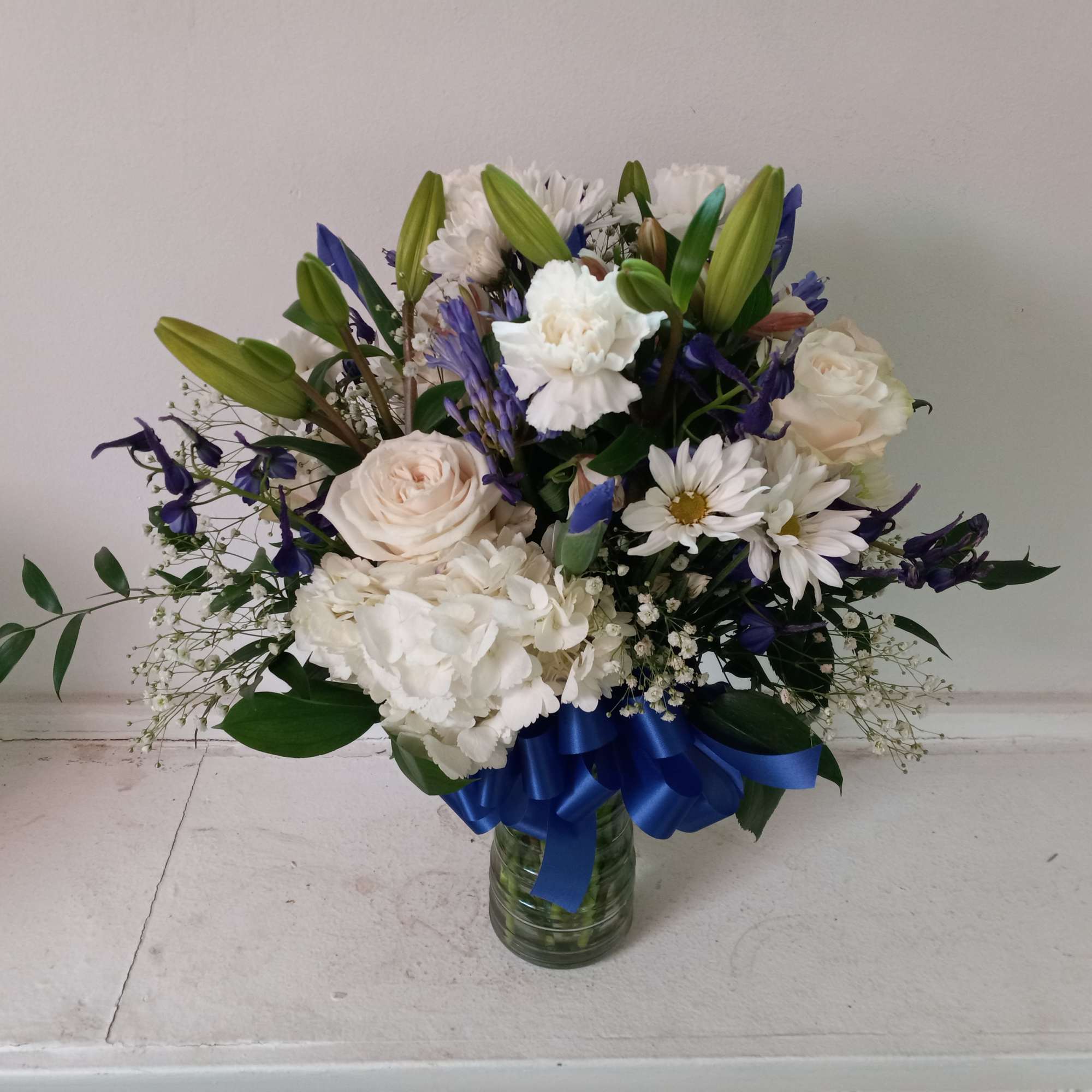 Beautiful mix of white roses, daisies, carnations, hydrangea &amp; navy/blue irises, statice