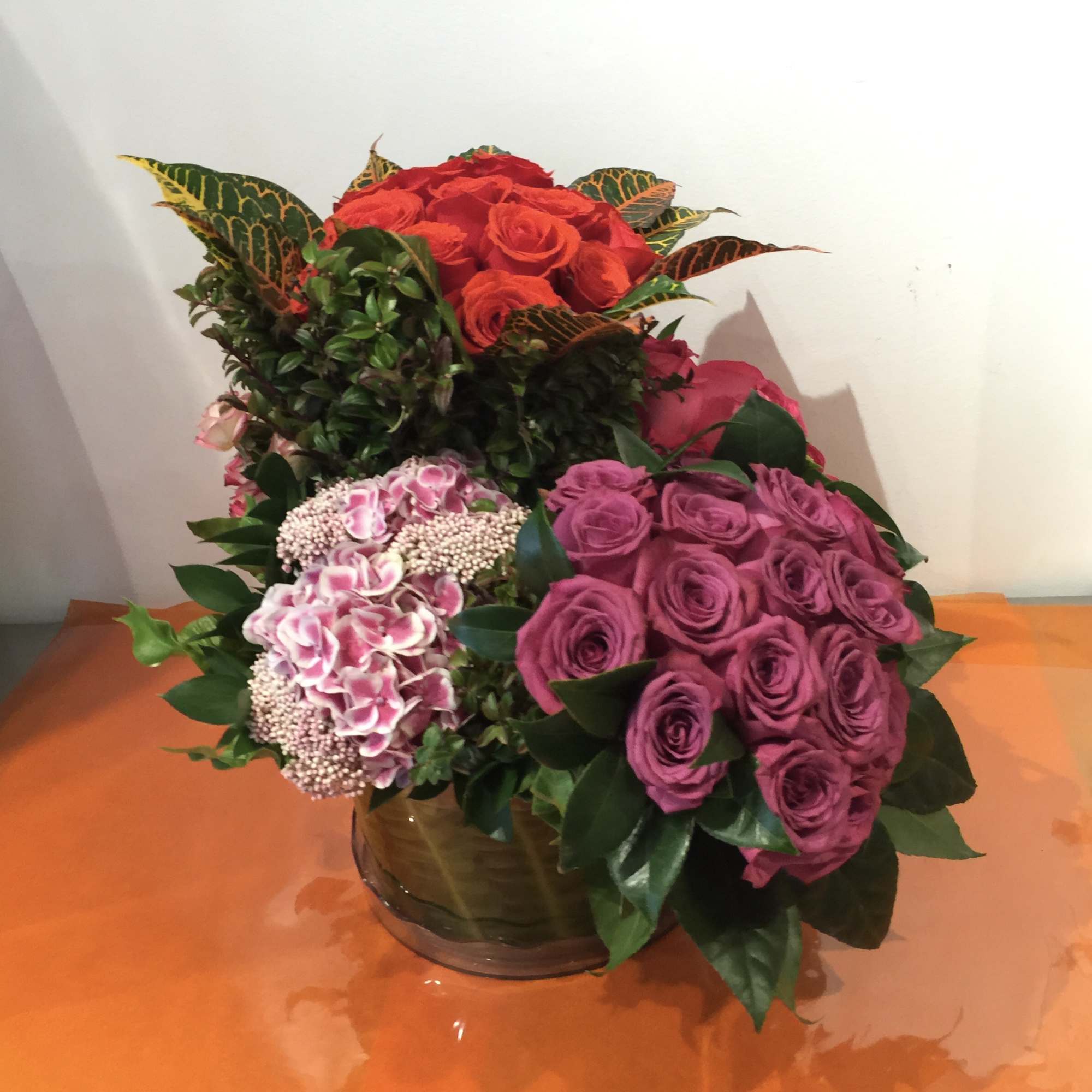 Custom tricolor rose arrangement with purple, pink, and orange roses, pink spray Custom tricolor rose arrangement with purple, pink, and orange roses, pink spray