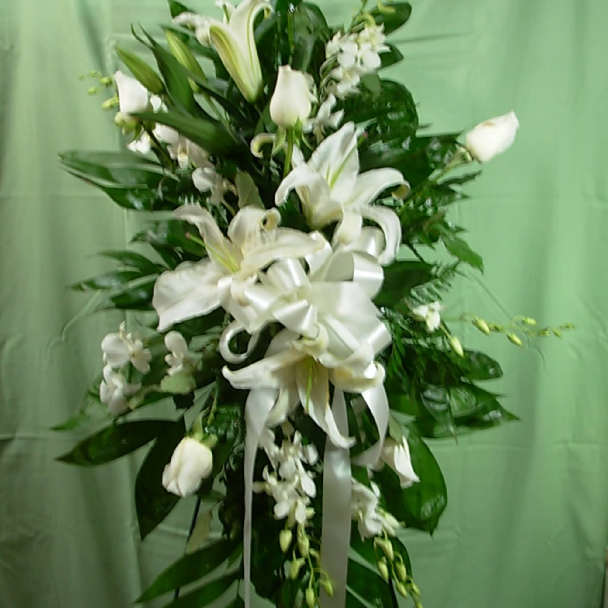 Our ROSE and ORCHIDS STANDING SPRAY is made of all white flowers