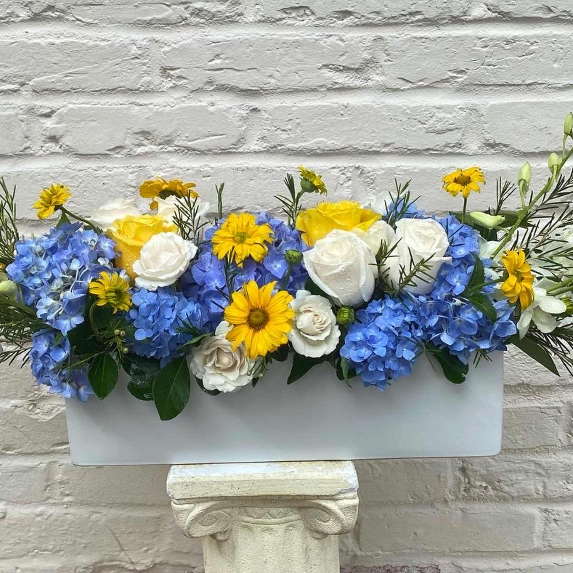 Arrangement of blue hydrangea  and white roses, daisies, accented with fresh Arrangement of blue hydrangea  and white roses, daisies, accented with fresh