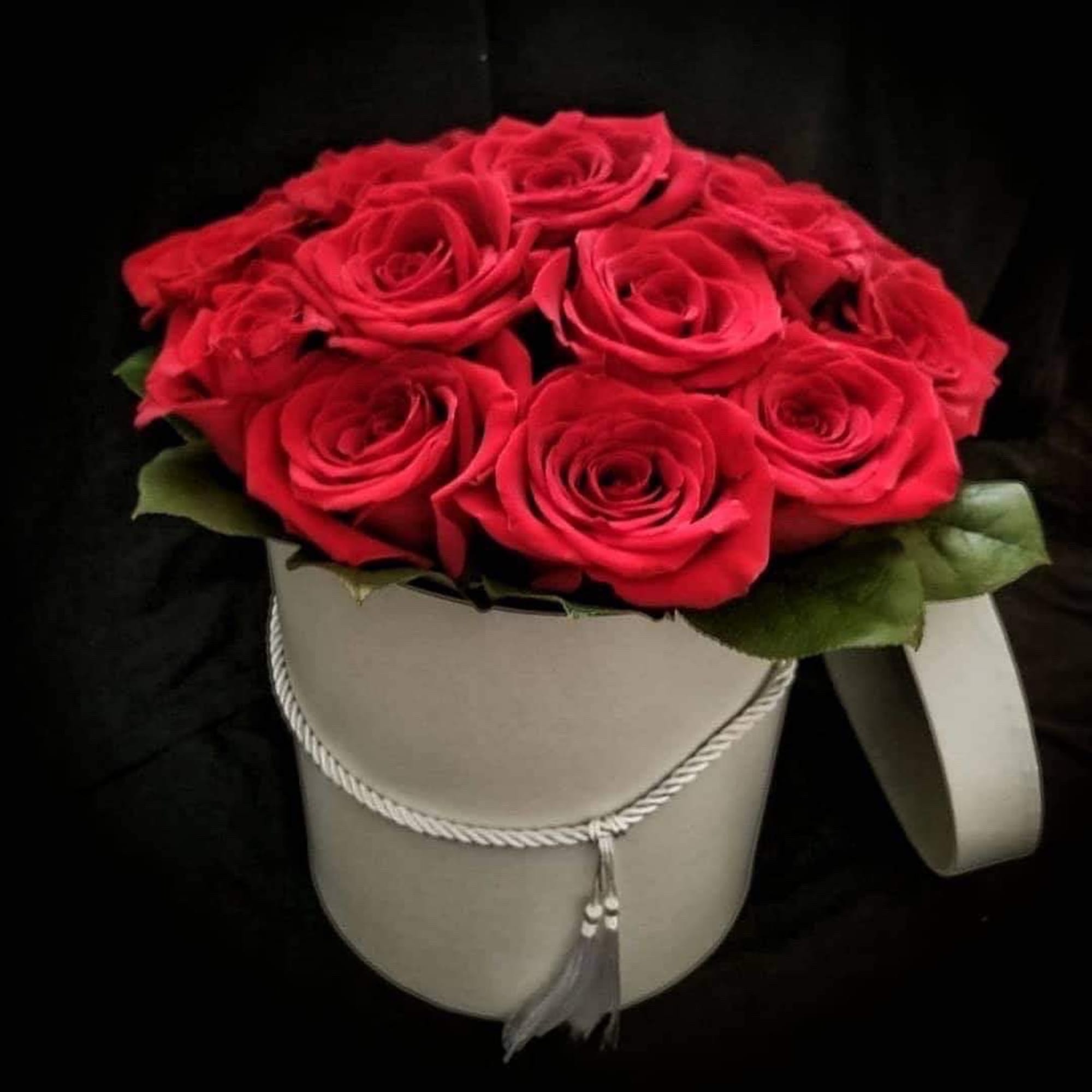 One dozen luxury red roses in a circular box. 