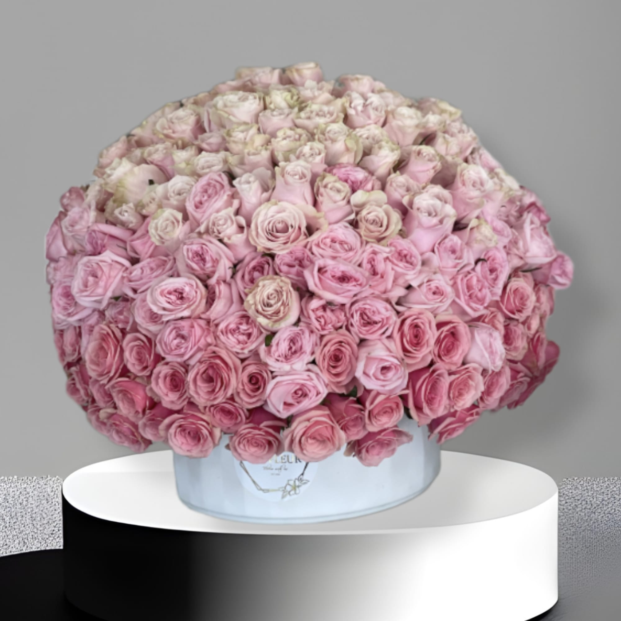 This arrangement comes in a round clay vase filled with filled with