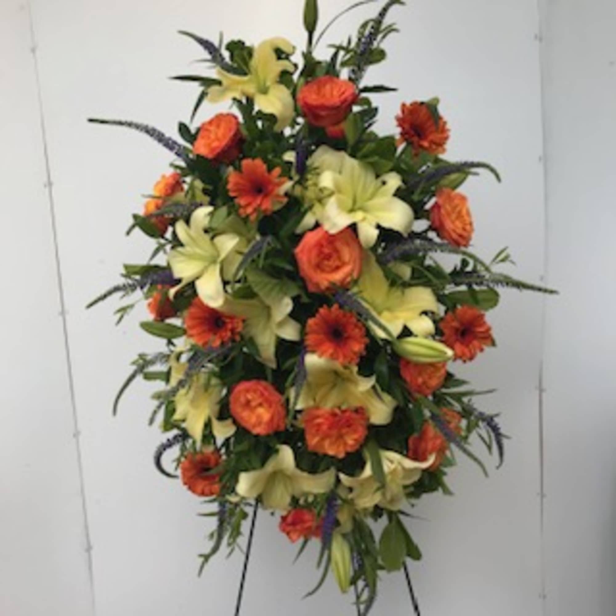 Standing sympathy spray including hydrangea, lilies, roses and other seasonal mixed fresh