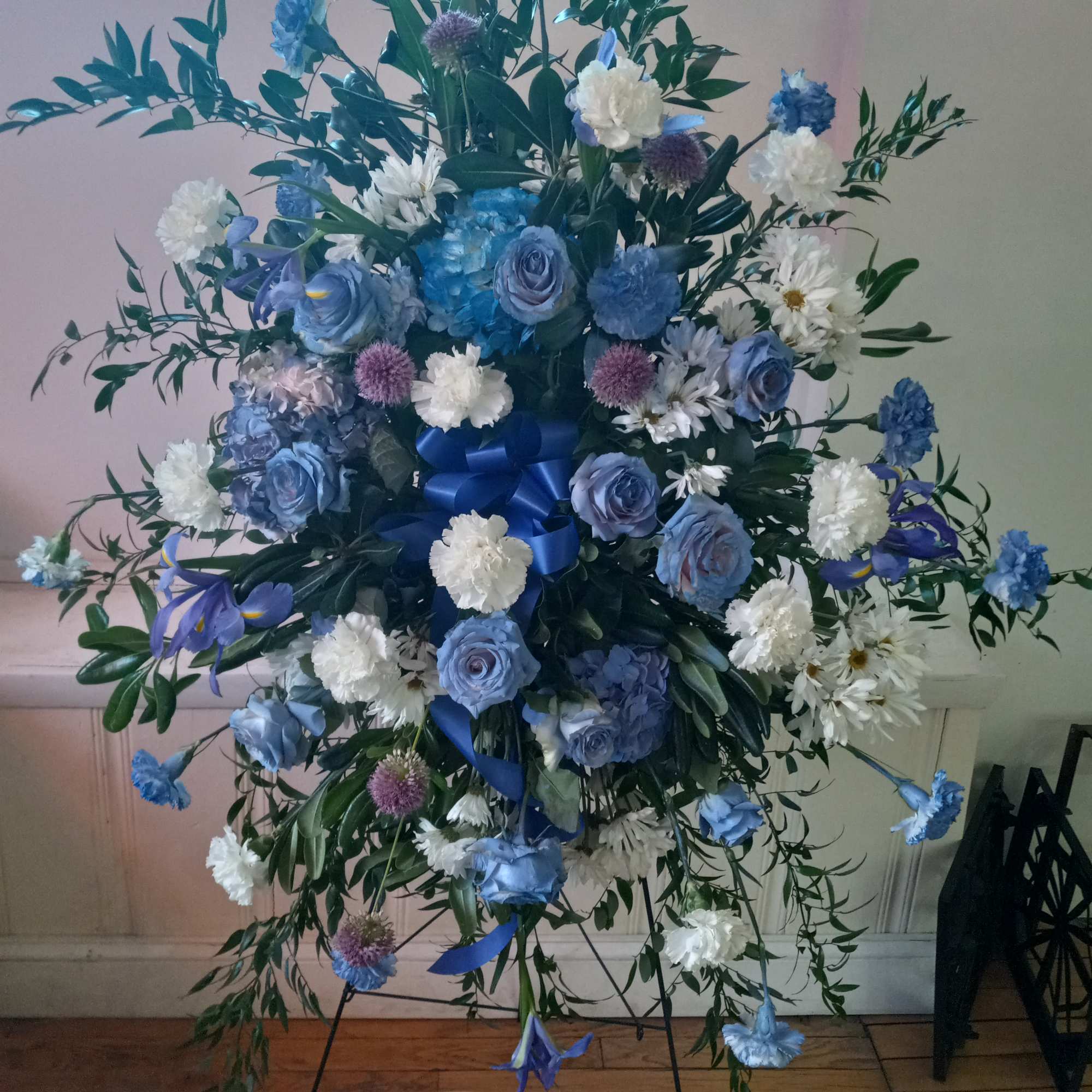 Stunning and unusual "Blue Lagoon" standing spray contains tinted blue roses, carnations