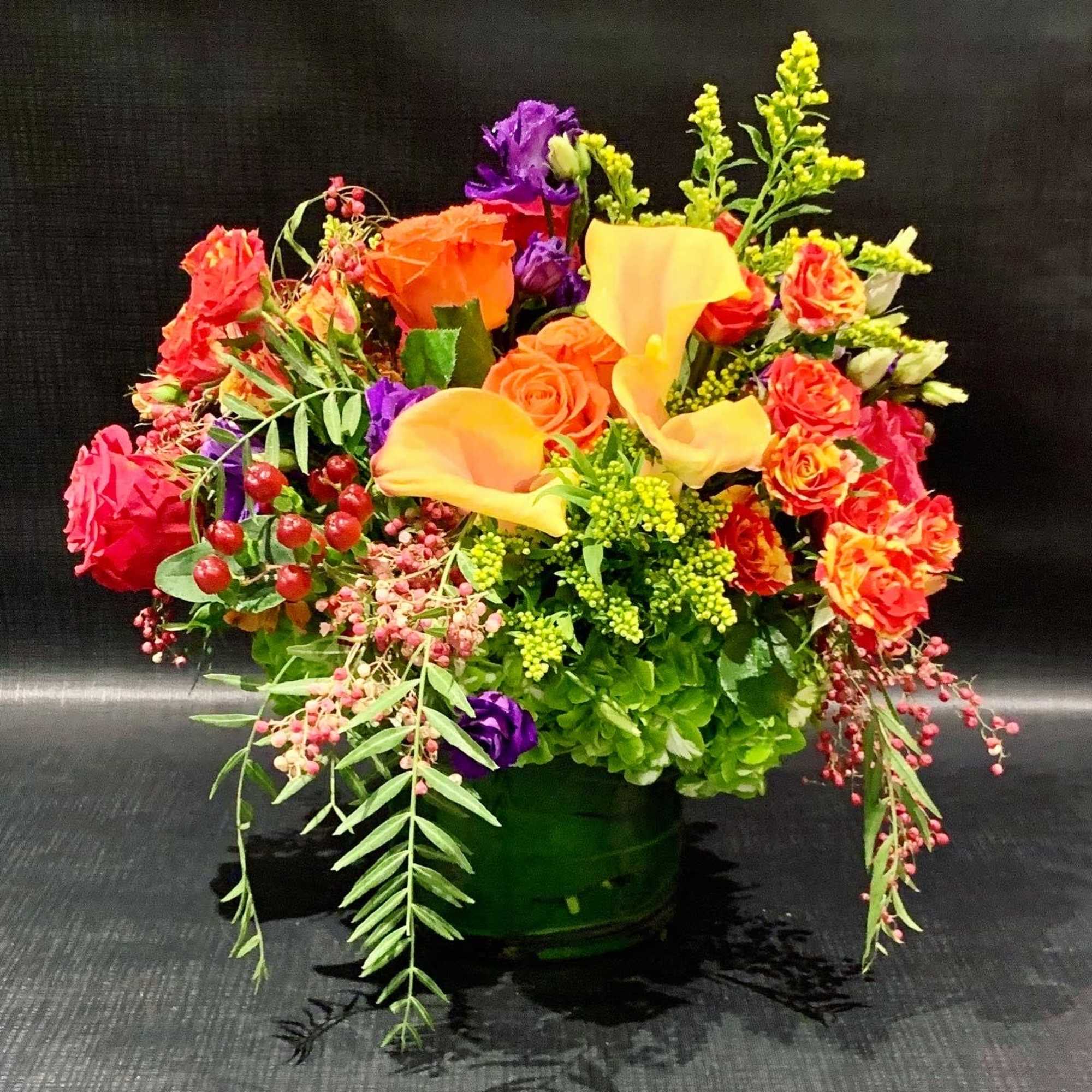 Custom arrangement of hydrangea, roses, lisianthus &amp; calla lilies in clear glass