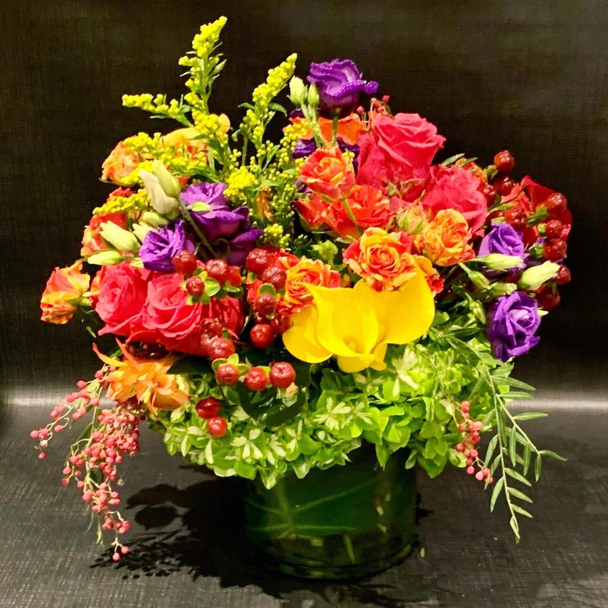 Custom arrangement of hydrangea, roses, lisianthus &amp; calla lilies in clear glass