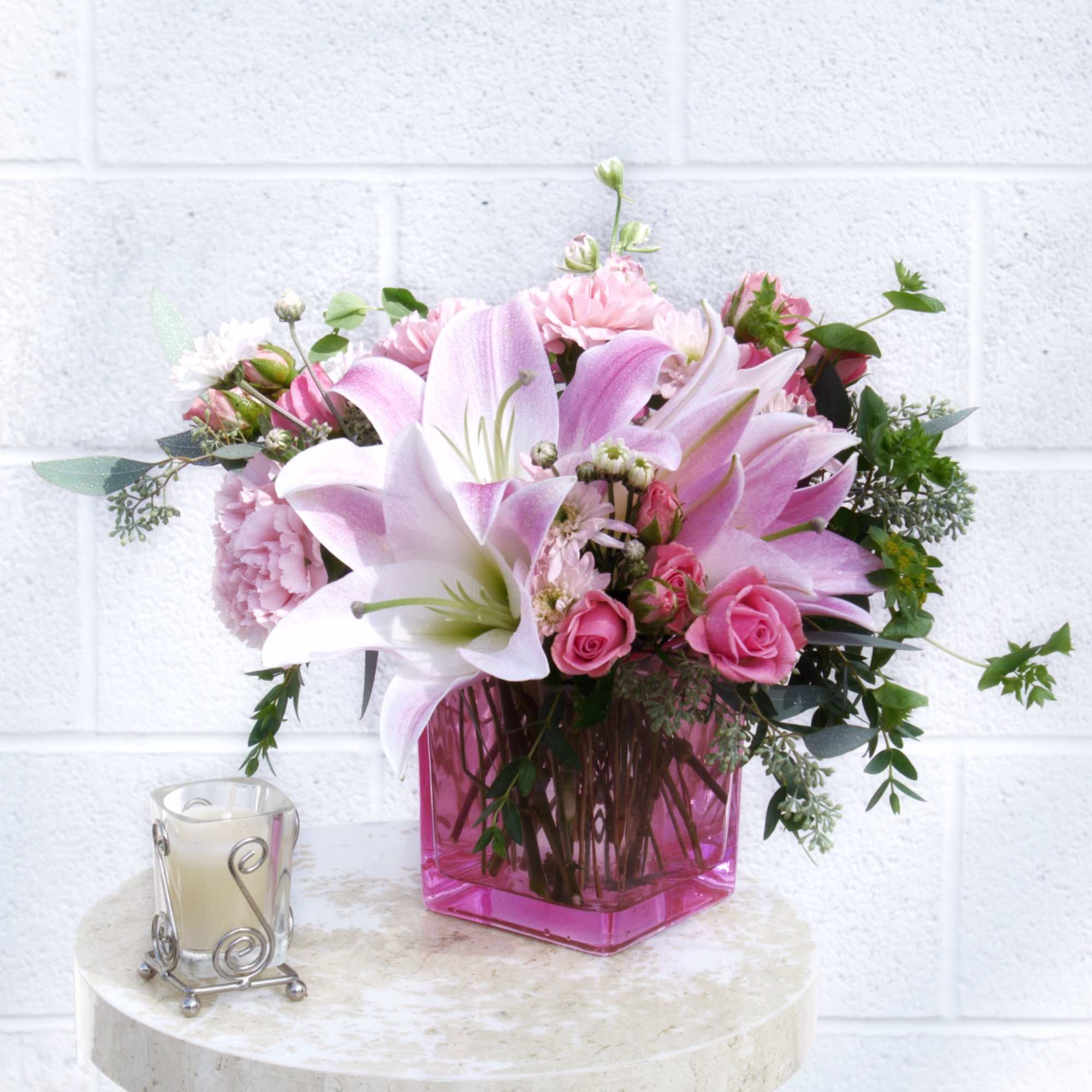 Sweet pink including lily, rose, fragrant stock, pompon and accents in a Sweet pink including lily, rose, fragrant stock, pompon and accents in a