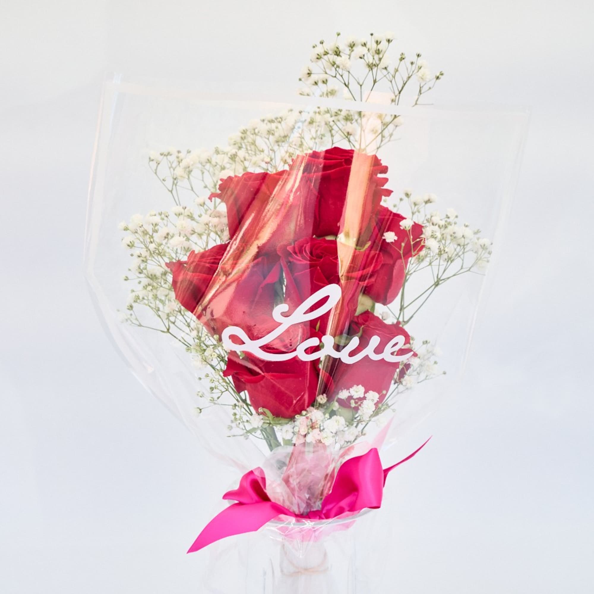 Red Roses with Baby's Breath bouquet.
Wrapped in a clear "Love" print cellophane.
Tied Red Roses with Baby's Breath bouquet.
Wrapped in a clear "Love" print cellophane.
Tied