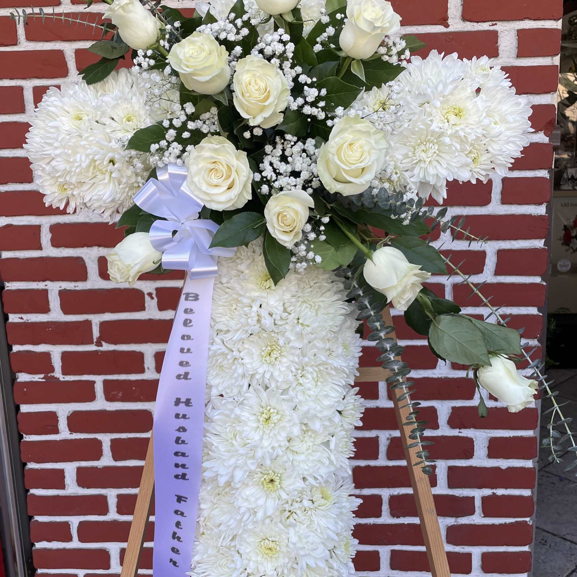 An all white tribute, this white cross funeral spray is pure and An all white tribute, this white cross funeral spray is pure and