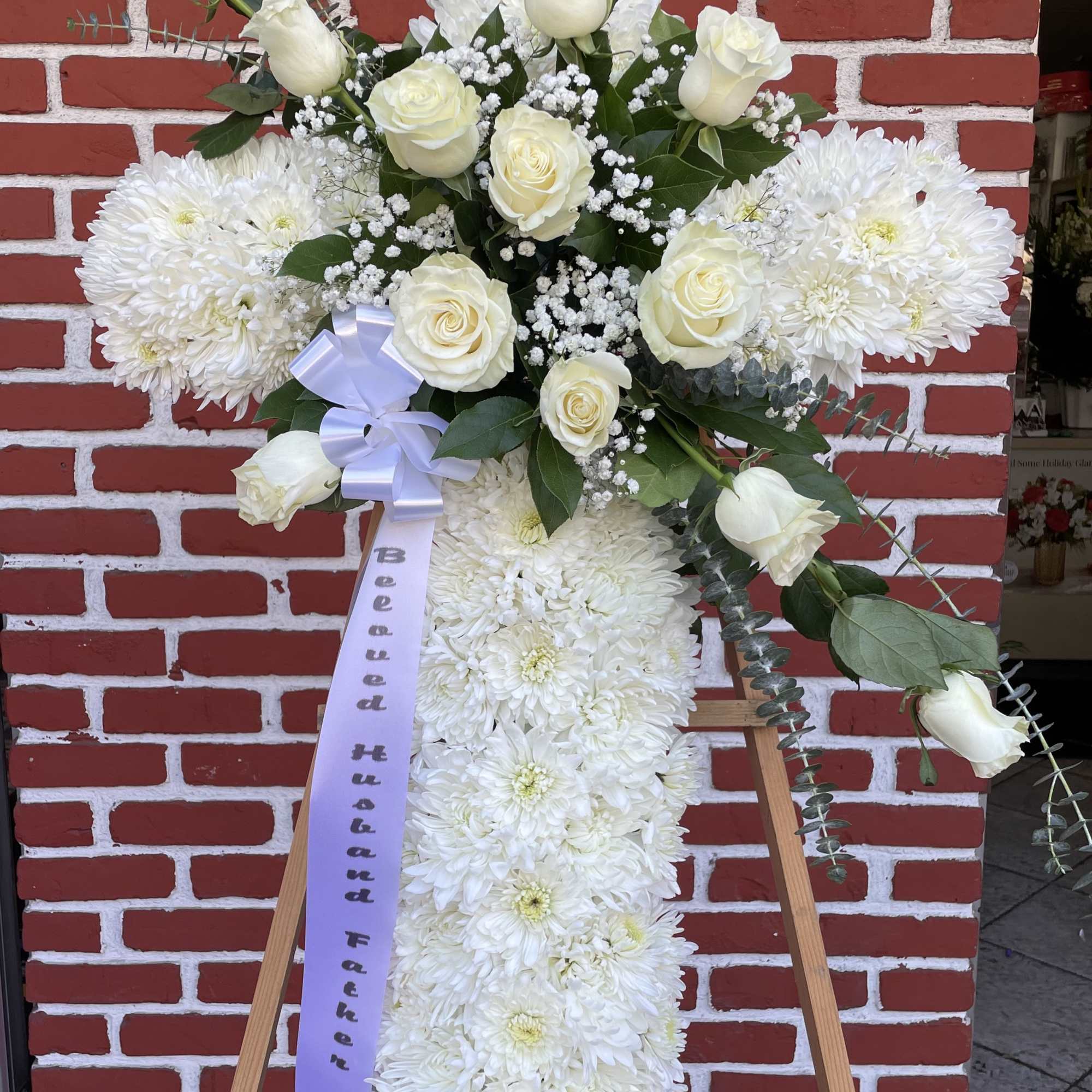 An all white tribute, this white cross funeral spray is pure and An all white tribute, this white cross funeral spray is pure and