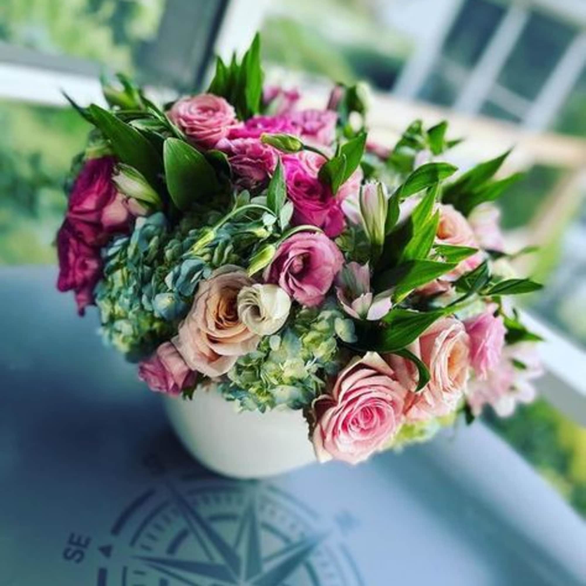 Compact and round arrangement that is timeless and classy for any occasion.