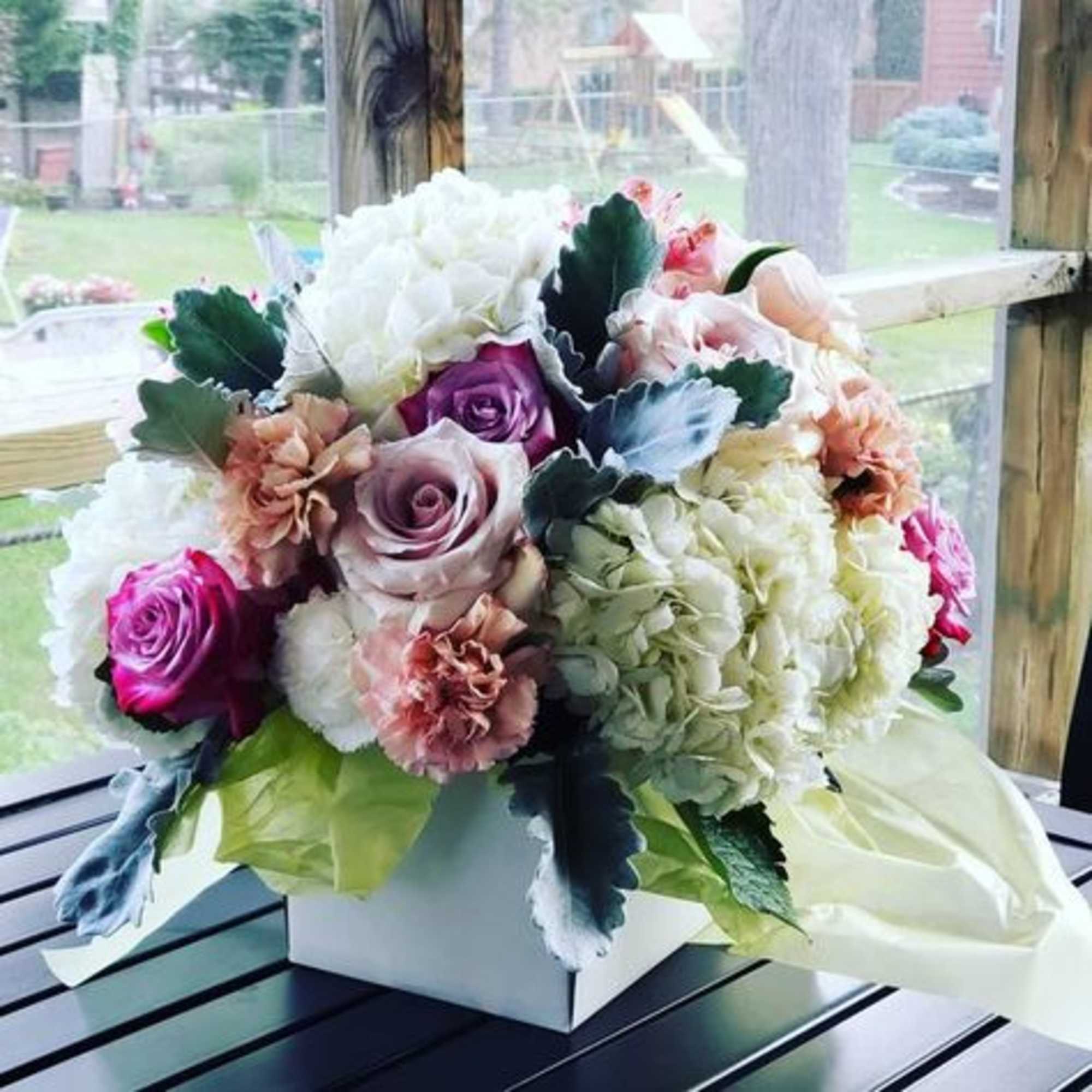 Compact and round arrangement that is timeless and classy for any occasion.