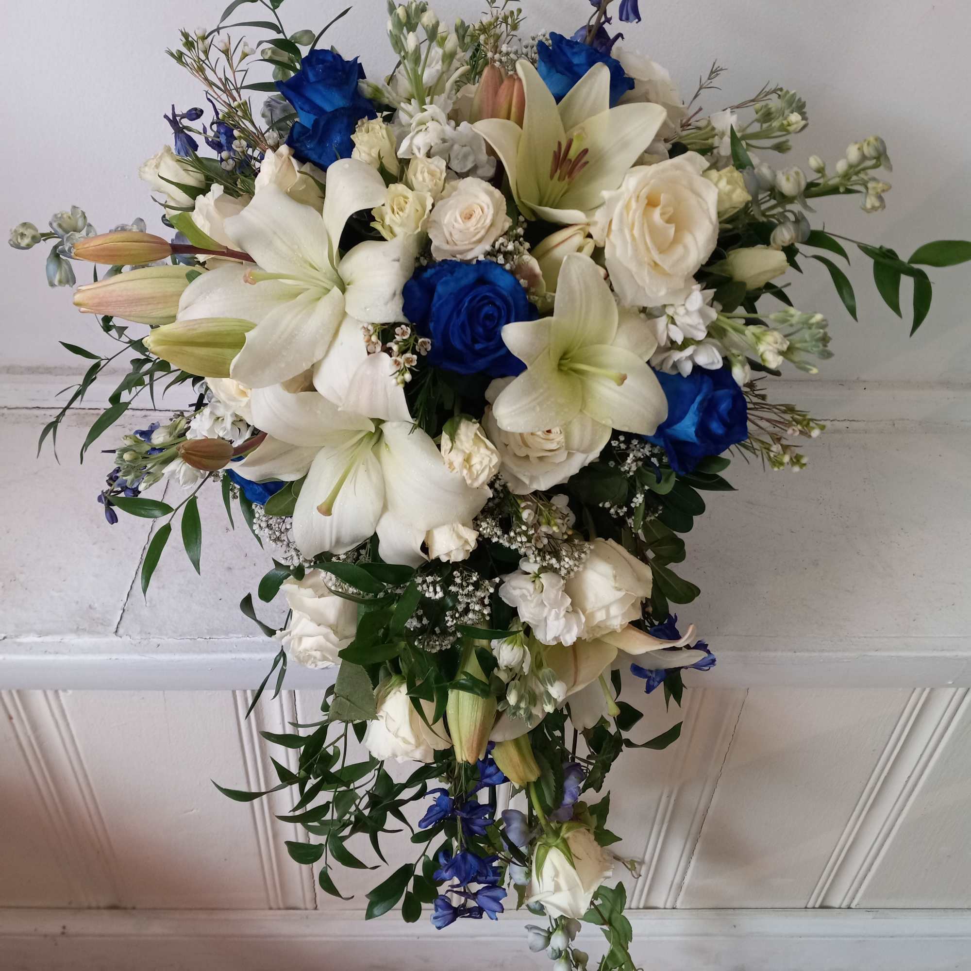 Beautiful white and navy- blue roses, white lilies, blue delphinium and white