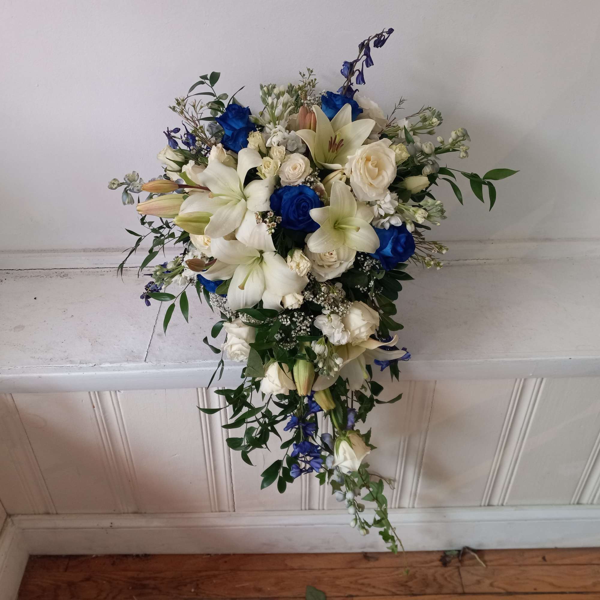 Beautiful white and navy- blue roses, white lilies, blue delphinium and white