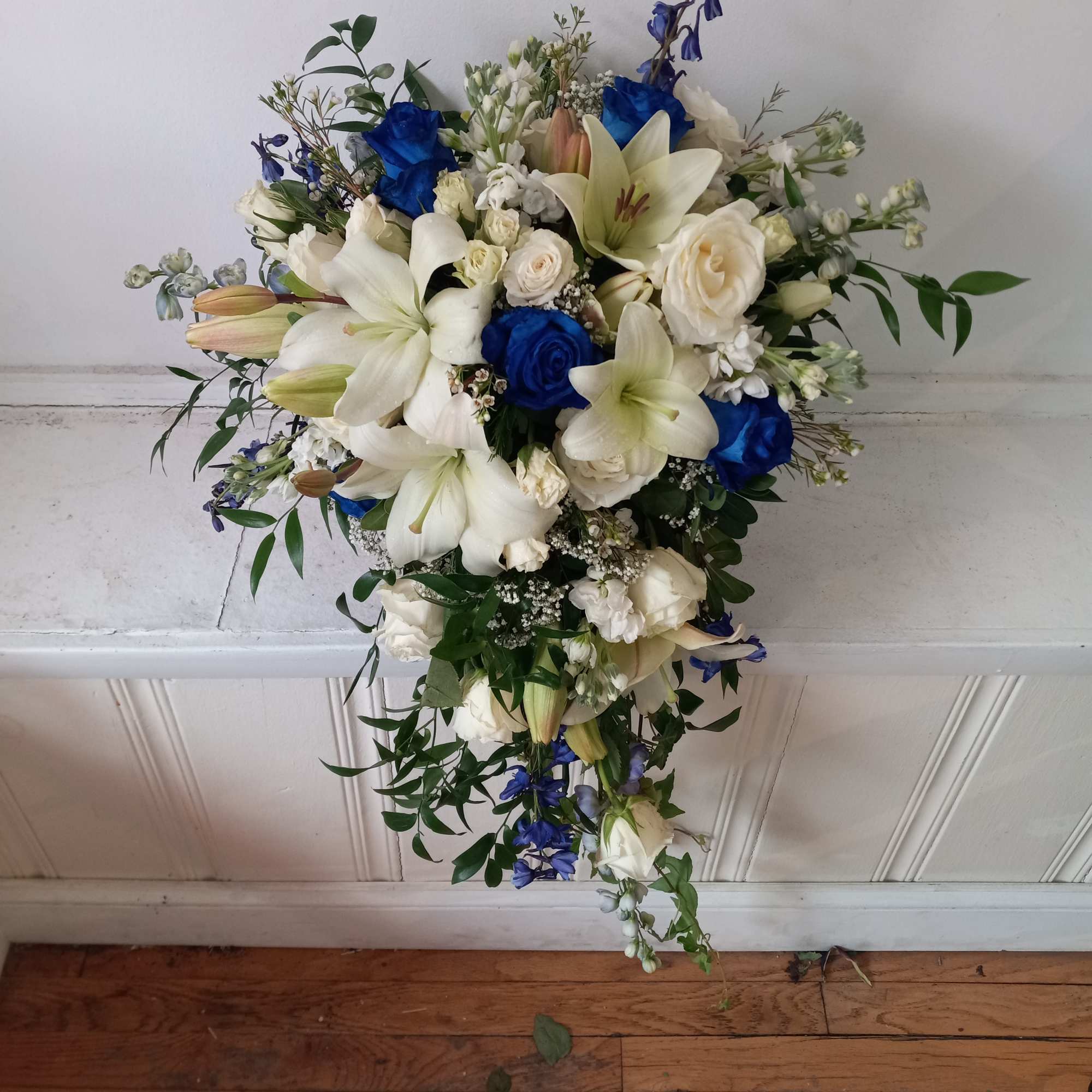 Beautiful white and navy- blue roses, white lilies, blue delphinium and white