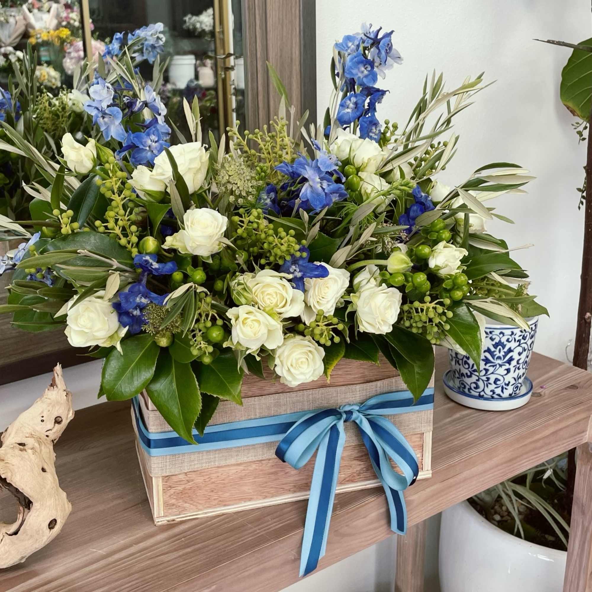 Blue-toned arrangement in a custom made wooden box. 