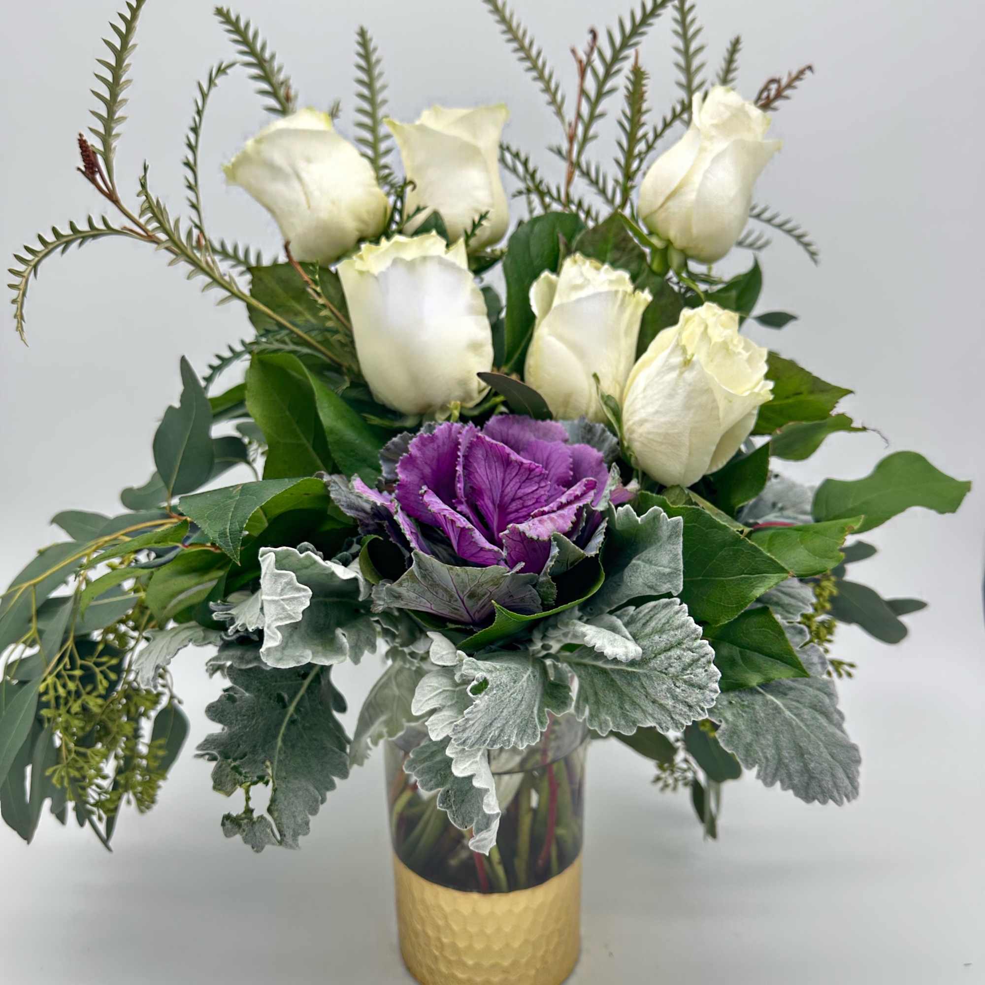Long stem white roses, purple kale, dusty miller, and seeded eucalyptus Long stem white roses, purple kale, dusty miller, and seeded eucalyptus