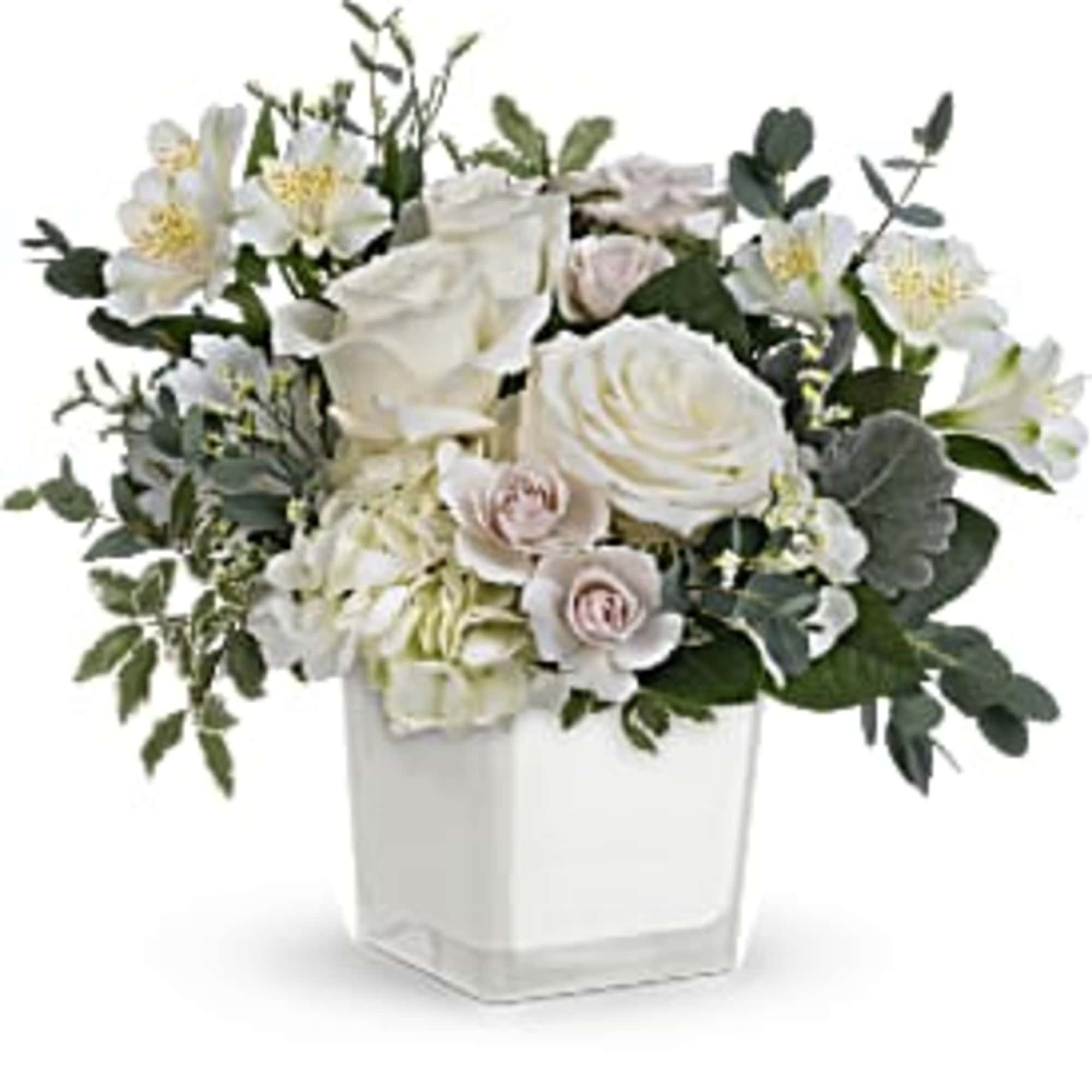 Elegant and serene, this wondrous white bouquet in a simple glass cube
