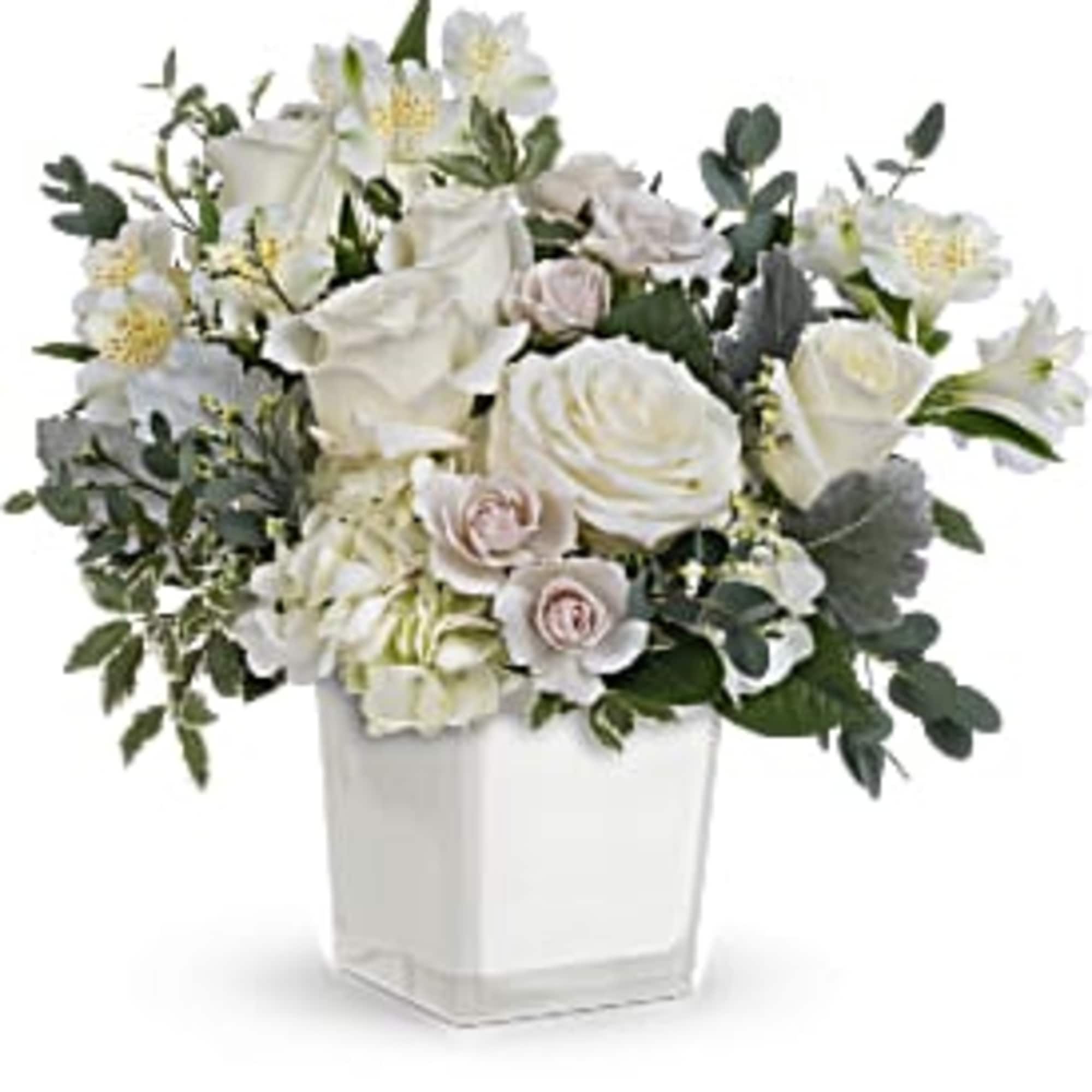 Elegant and serene, this wondrous white bouquet in a simple glass cube