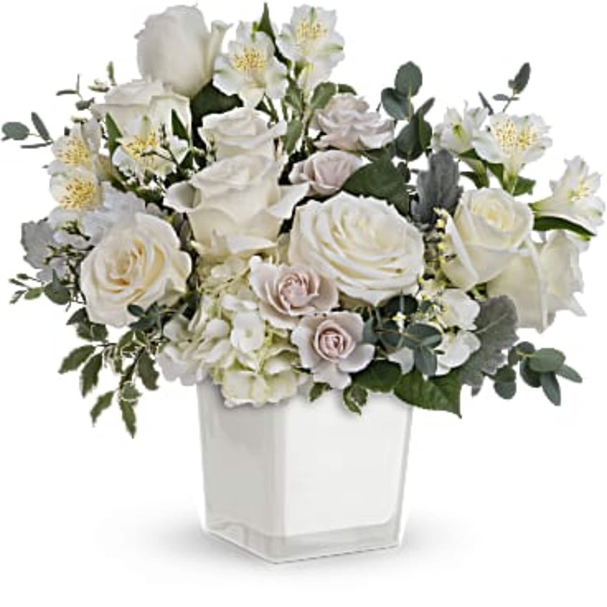 This peaceful arrangement includes white hydrangea, white roses, white spray roses, white