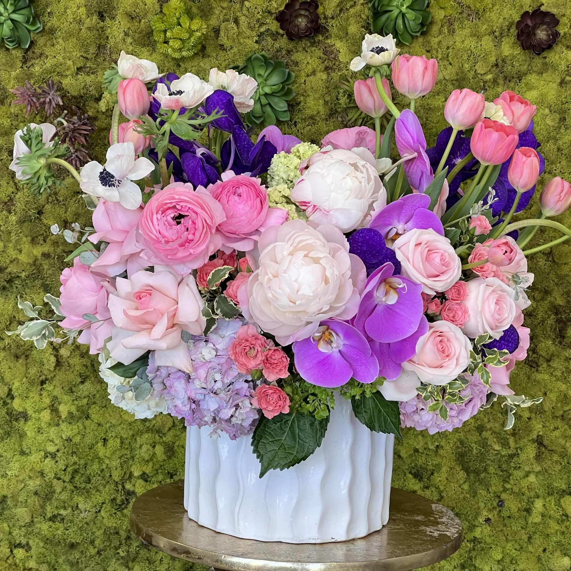 Fresh clusters of long-stem pink roses, antique pink hydrangeas, and white cymbidium
