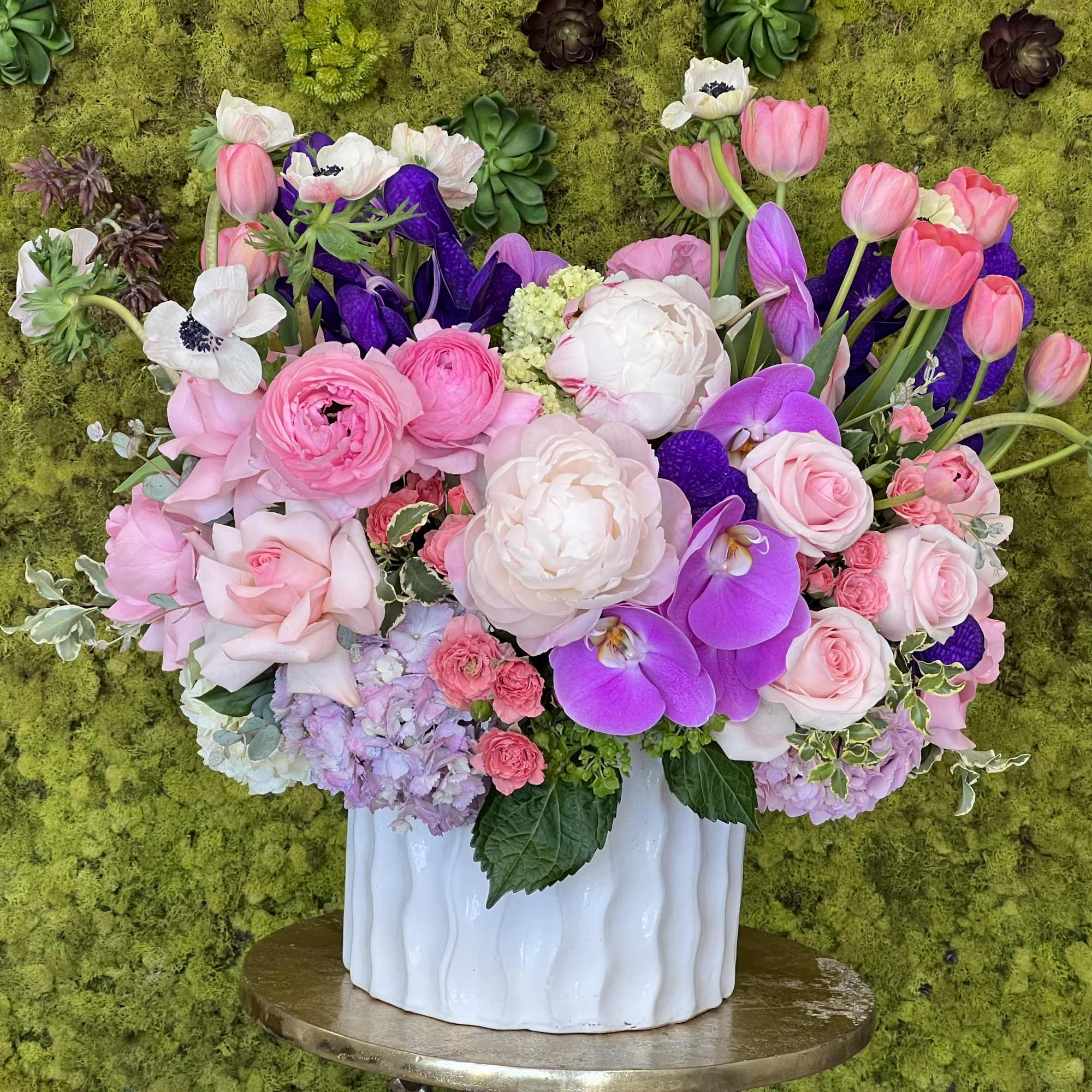Fresh clusters of long-stem pink roses, antique pink hydrangeas, and white cymbidium