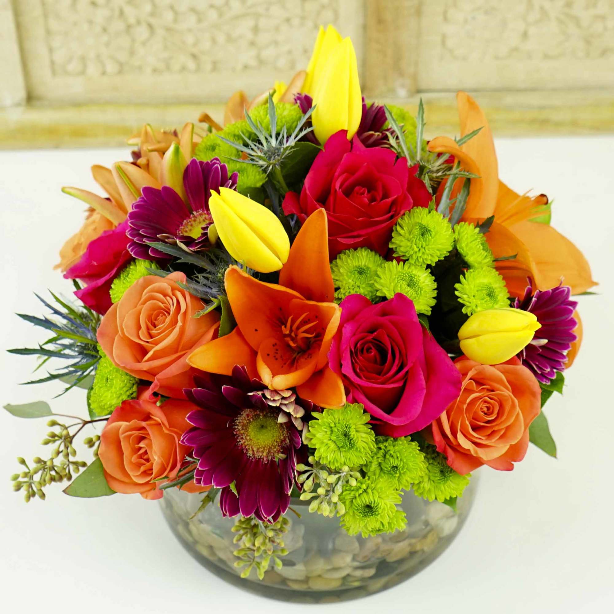 A colorful mixture of seasonal flowers such as Tulips, Asiatic Lilies &amp;