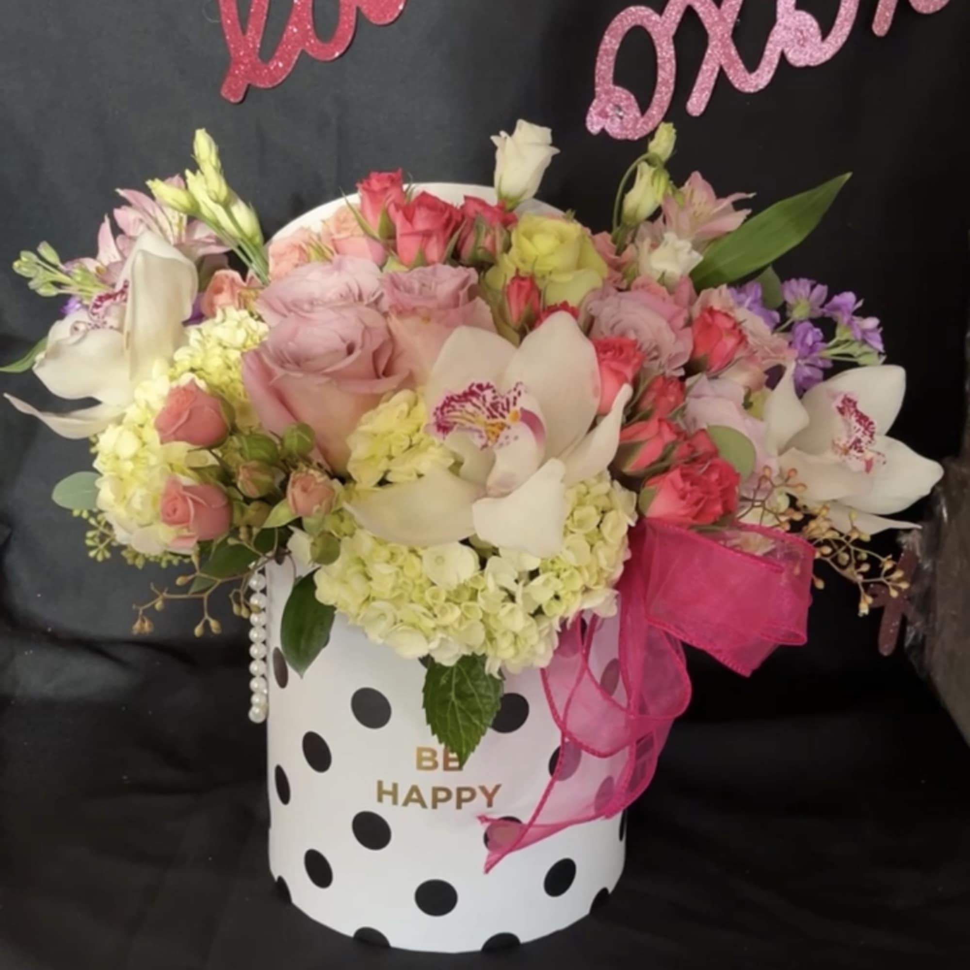 Tall cylinder box filled with a color mix of Roses, Orchids, Hydrangeas