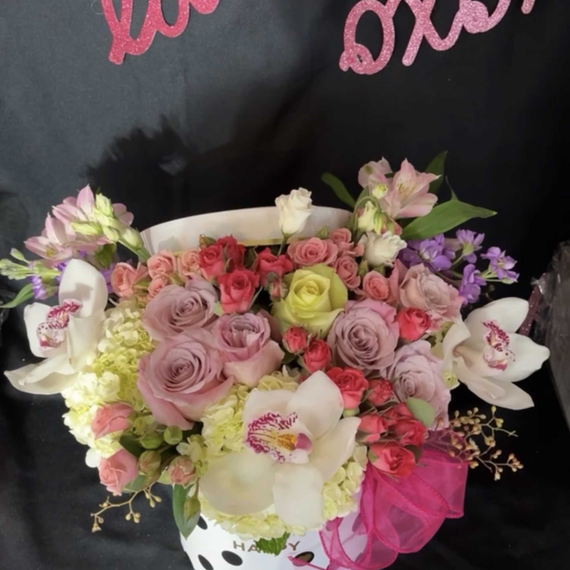 Tall cylinder box filled with a color mix of Roses, Orchids, Hydrangeas