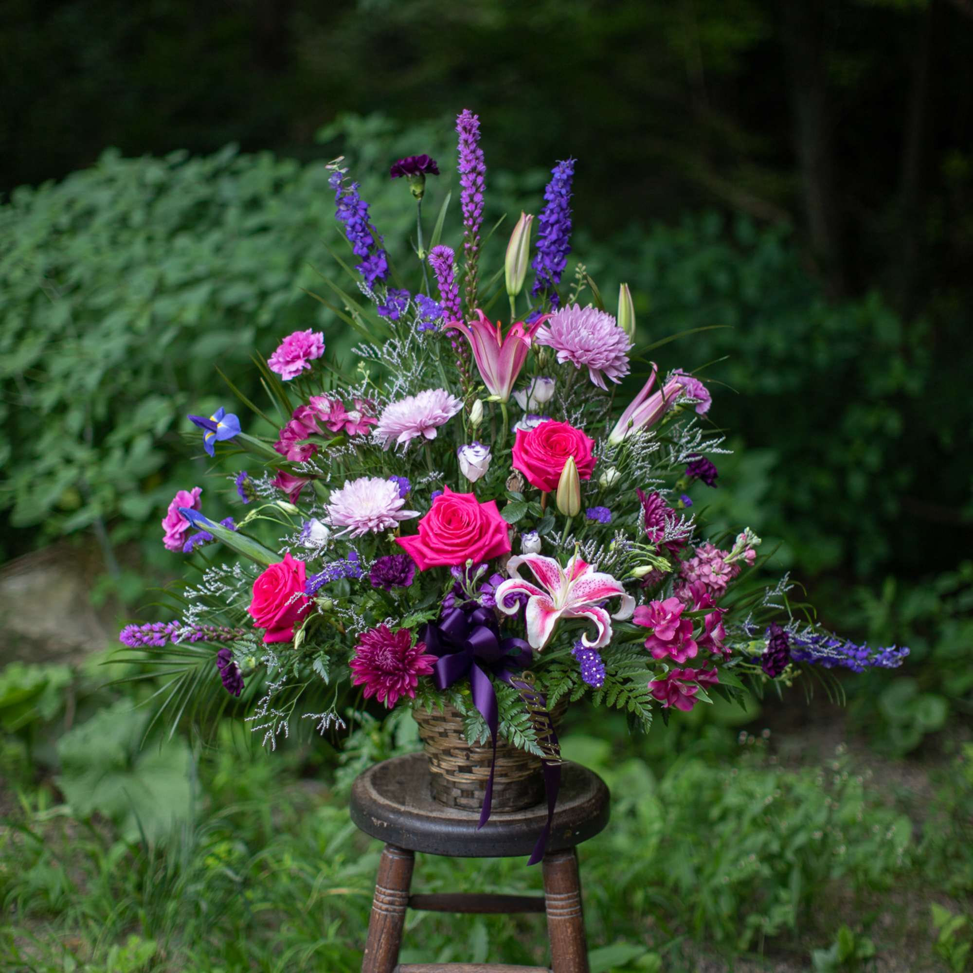Wildflower inspired floral tribute basket in lovely lavender, indigo and purple tones Wildflower inspired floral tribute basket in lovely lavender, indigo and purple tones
