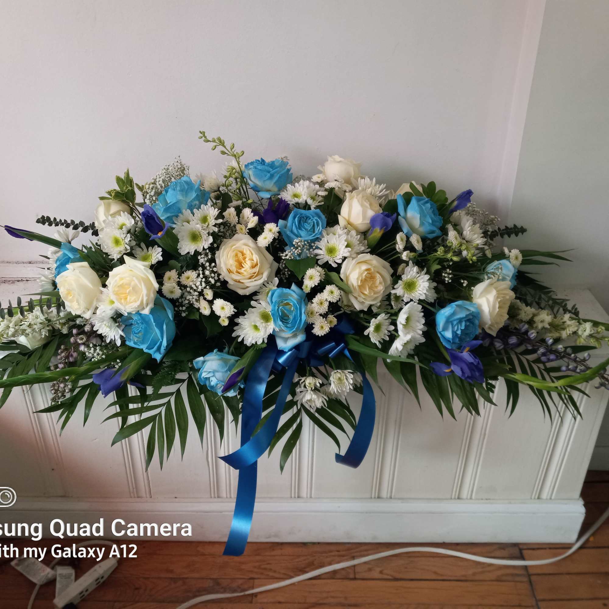 Light blue roses, Irises, white roses and daisies in a half a