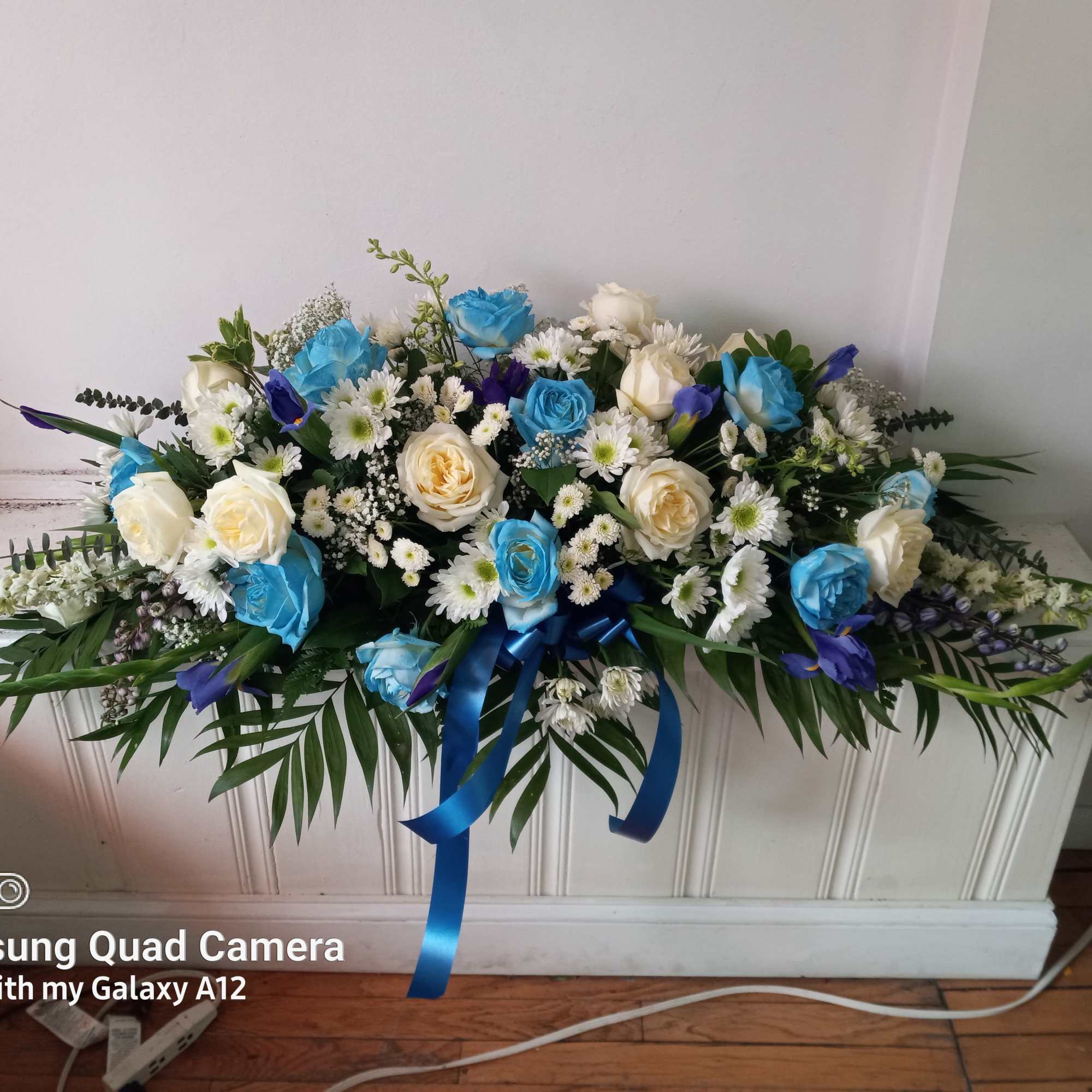 Light blue roses, Irises, white roses and daisies in a half a