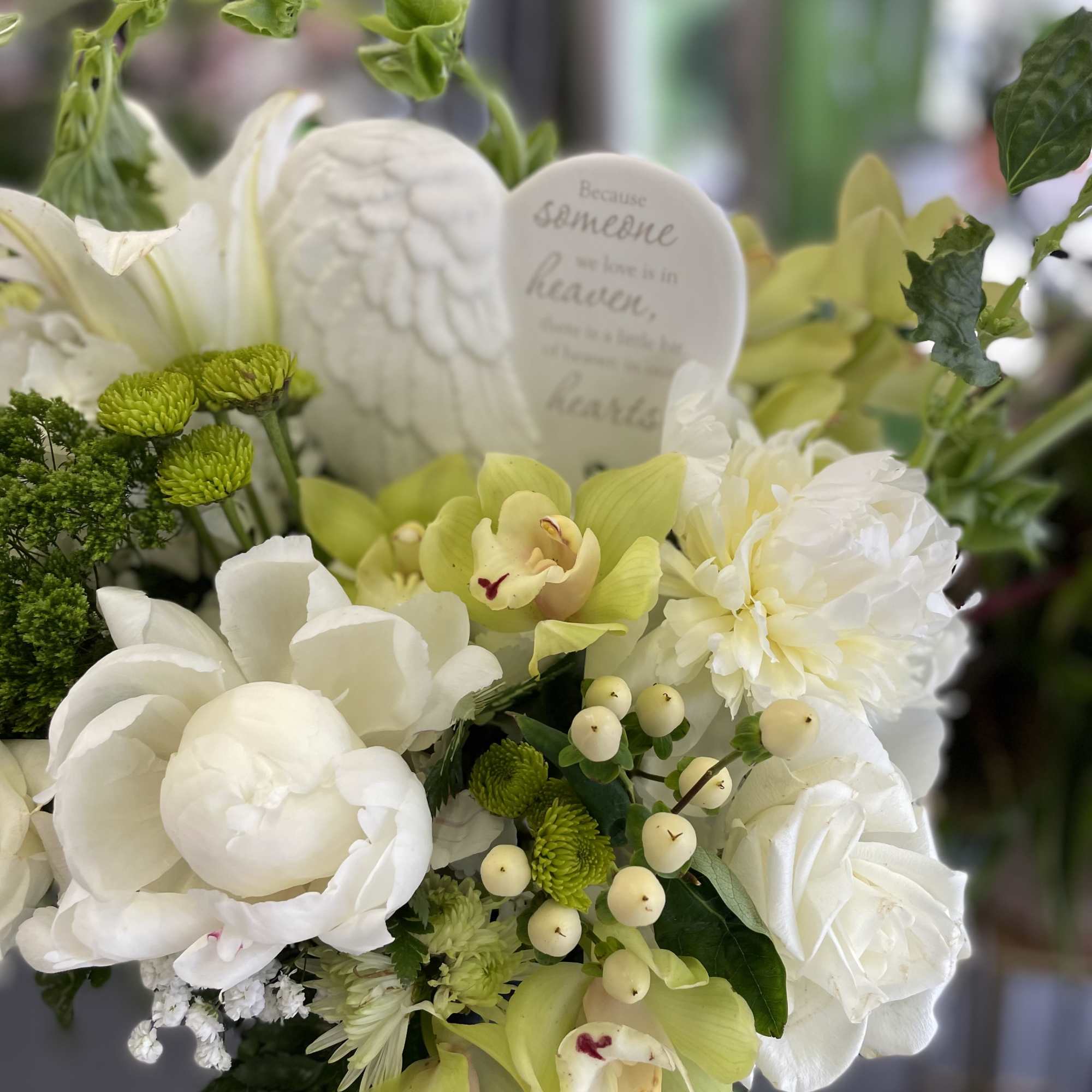 This beautiful arrangement has white combinations of flowers, and a good mix