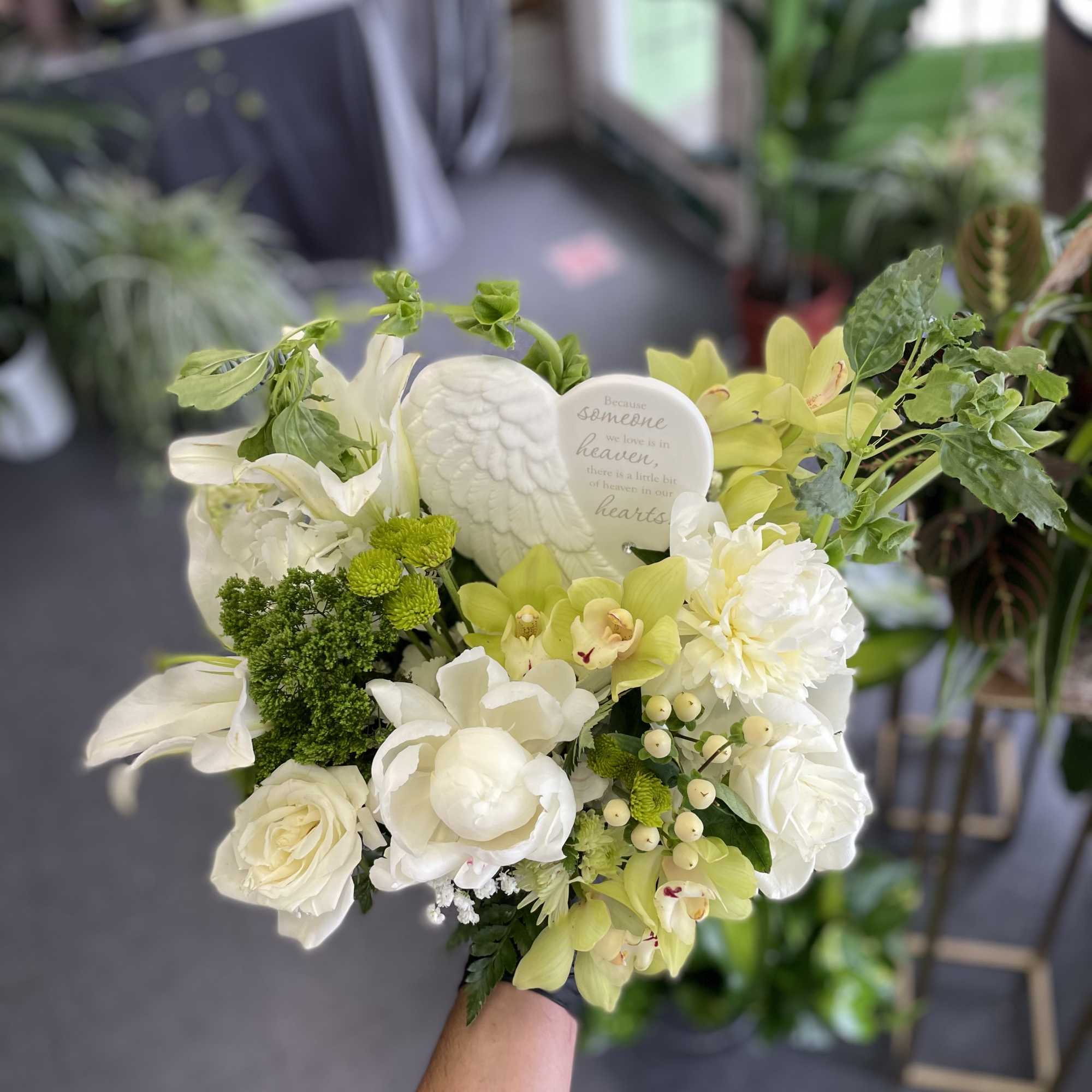 This beautiful arrangement has white combinations of flowers, and a good mix