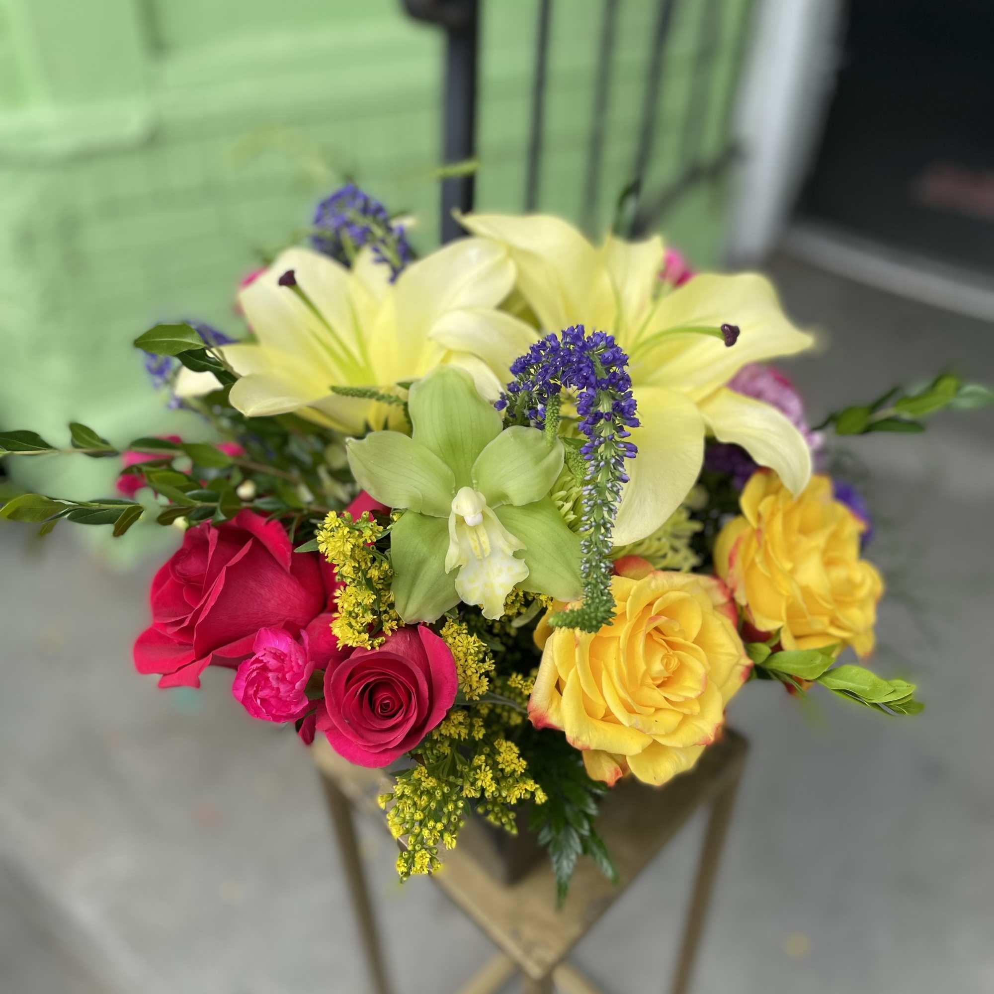 This beautiful arrangement has yellow lily&rsquo;s, yellow roses, green mums, mix carnations