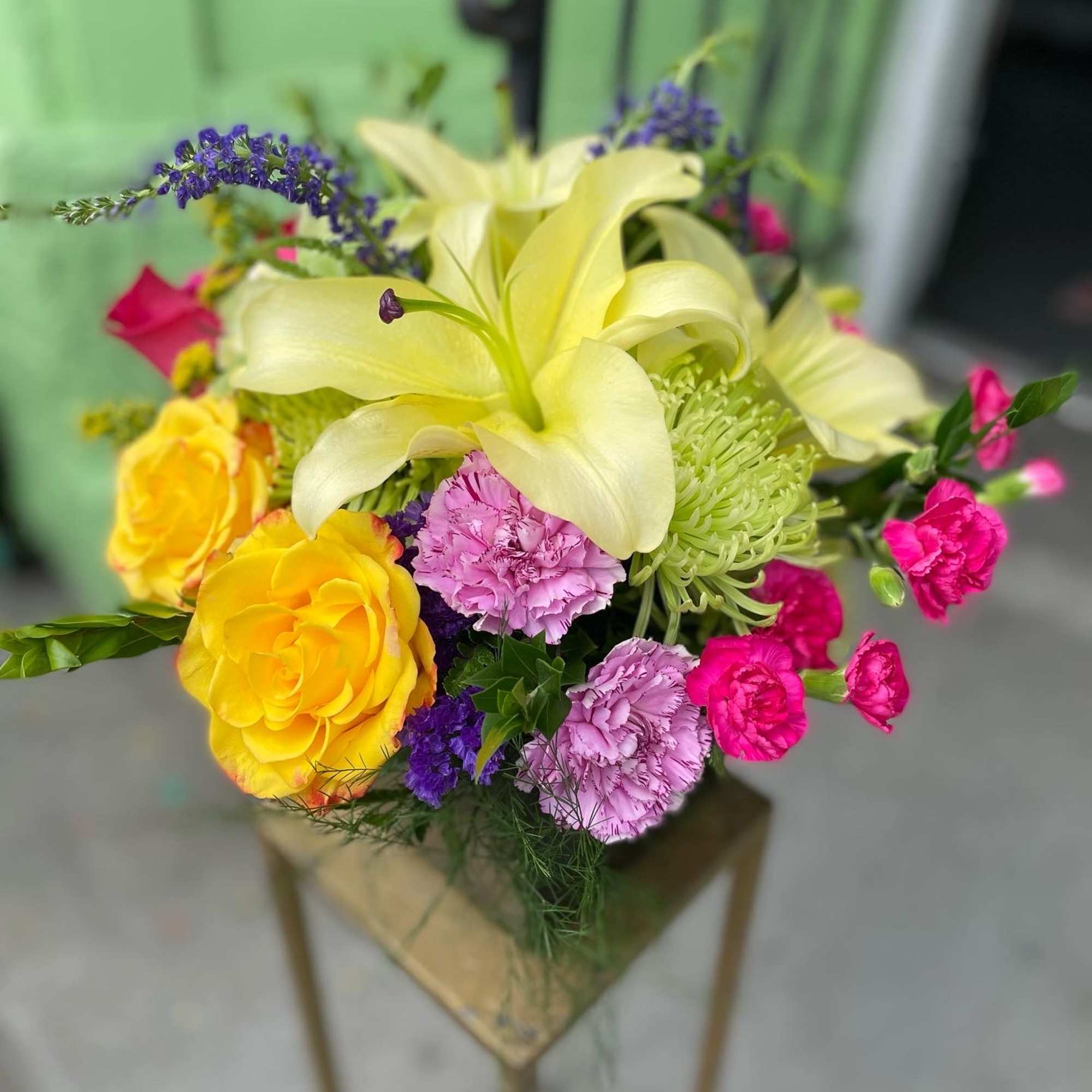 This beautiful arrangement has yellow lily&rsquo;s, yellow roses, green mums, mix carnations