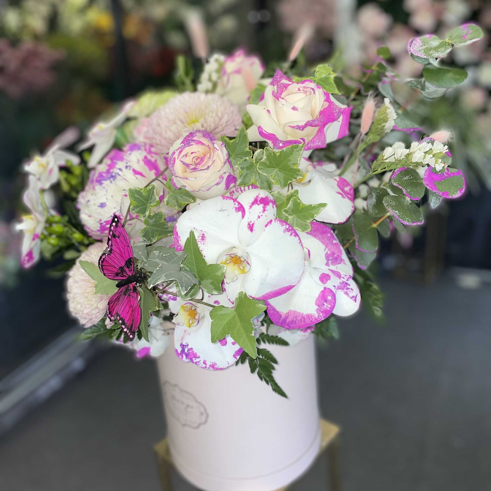 This beautiful arrangement has pink orchid, color roses, lavender mums, white hydrangea