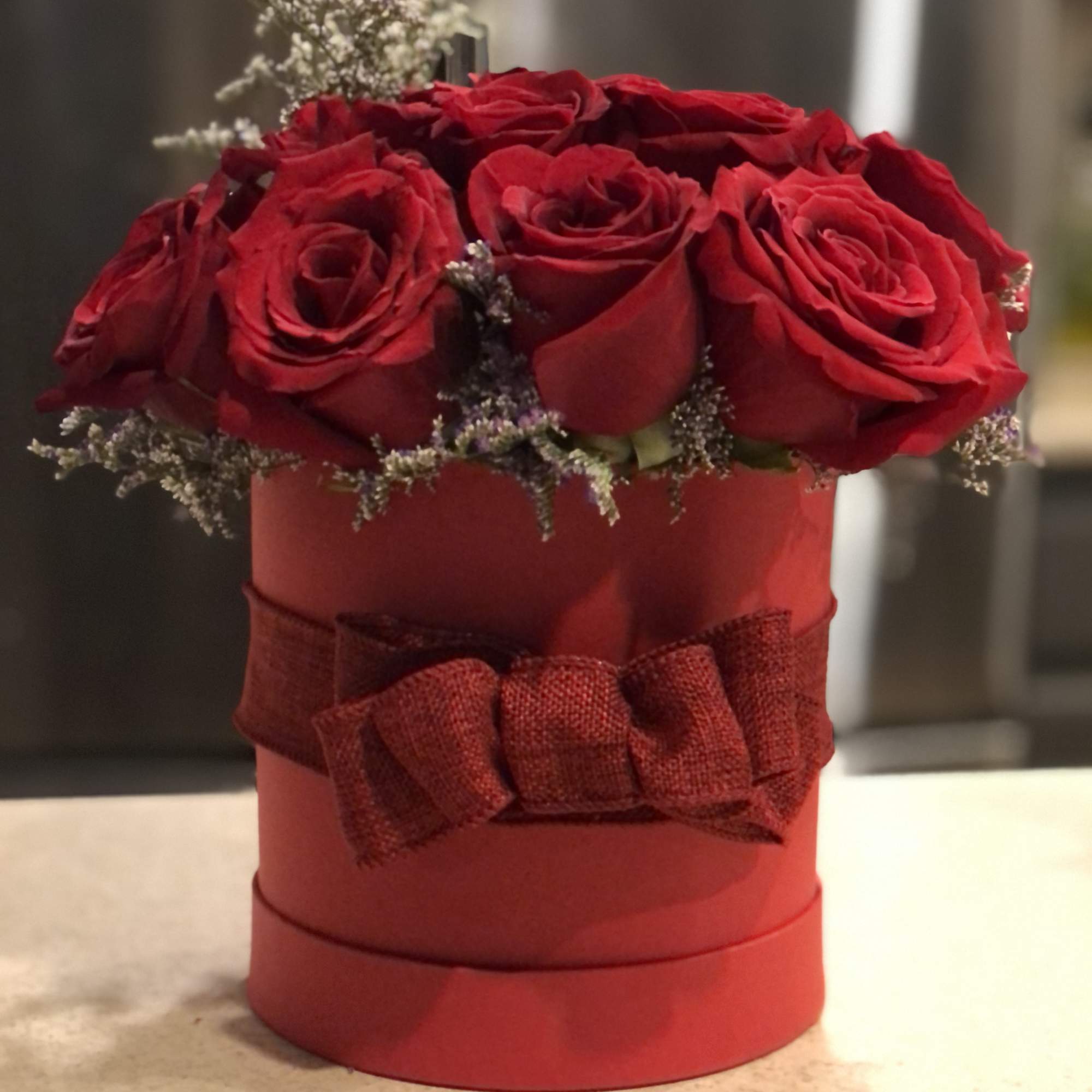 Red roses pillowed inside a round hat box