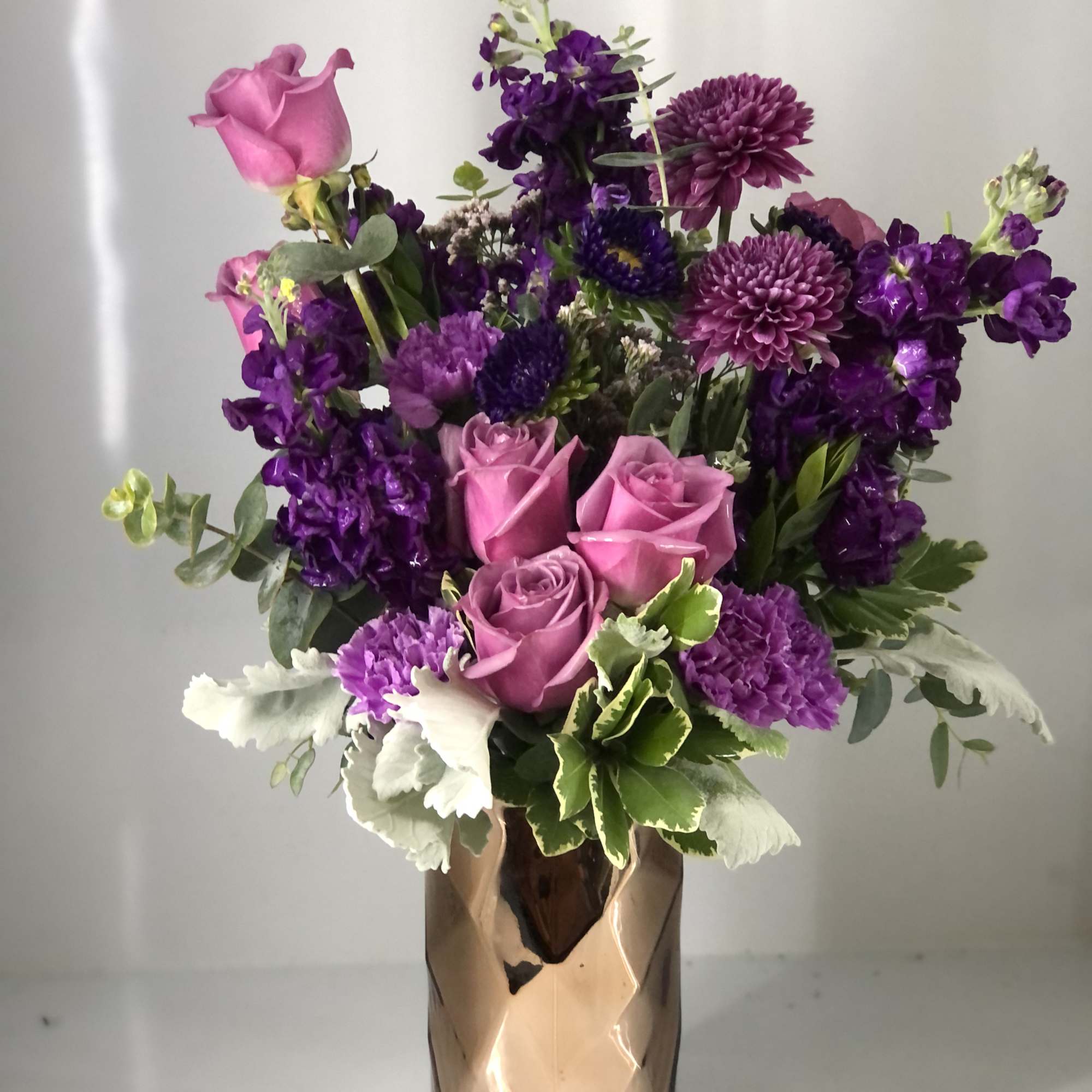 All lavender and purple blooms! In a classy gold vase (May change