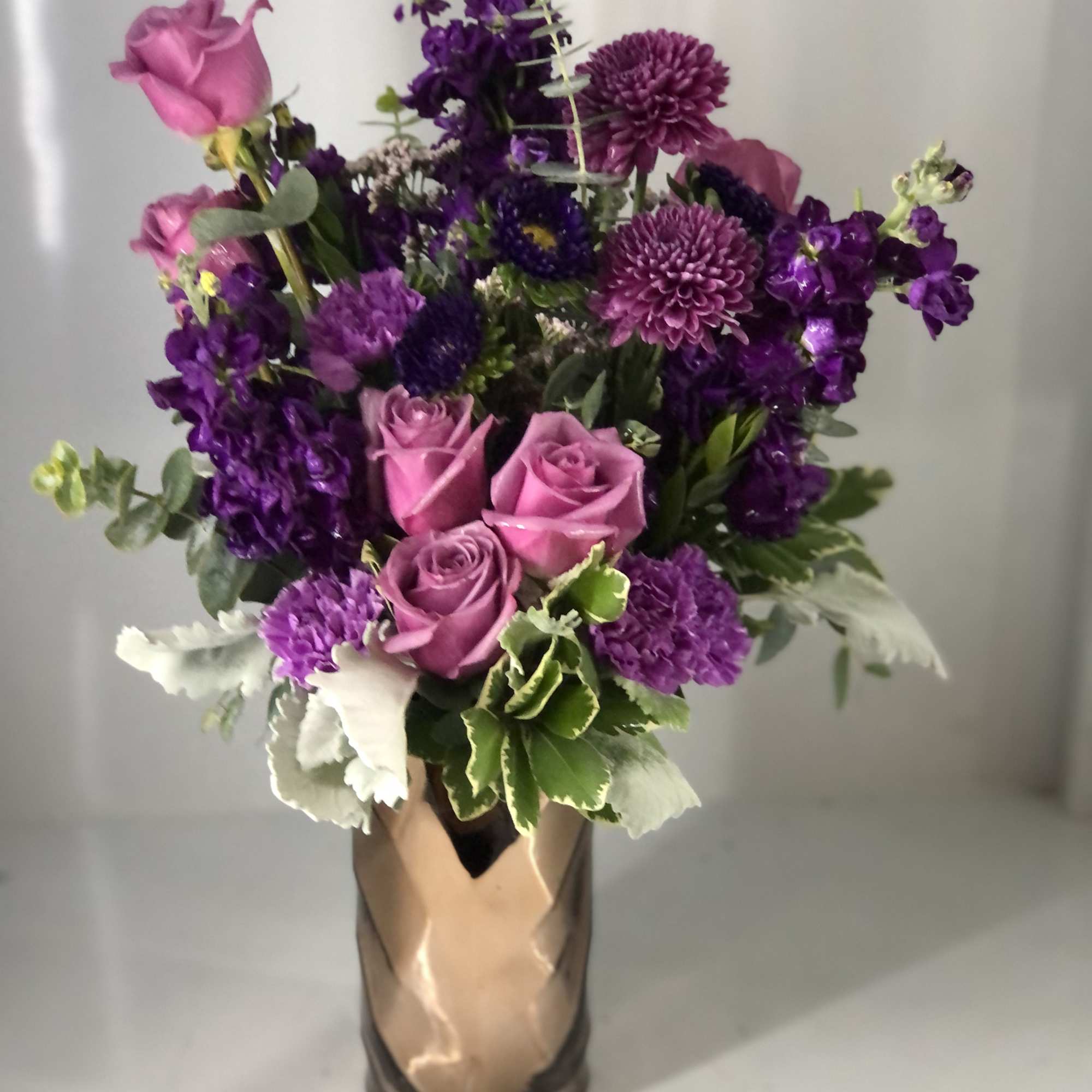 All lavender and purple blooms! In a classy gold vase (May change