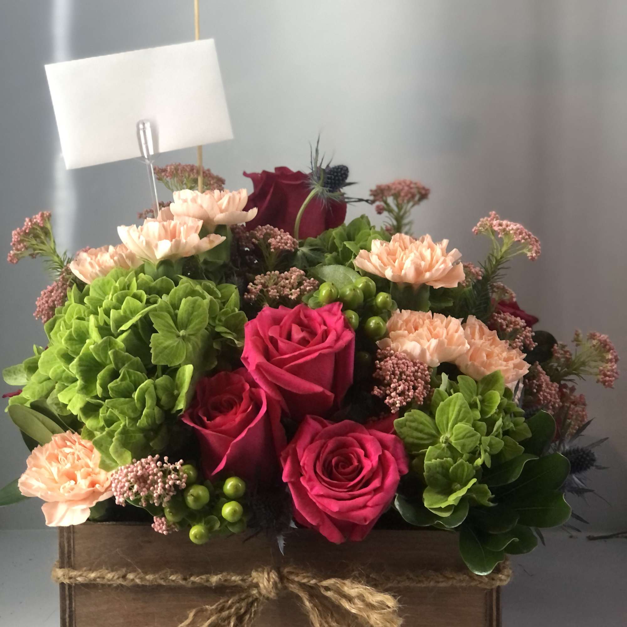 Hydrangeas, hot pink roses , carnations, and beautiful fillers , bring life